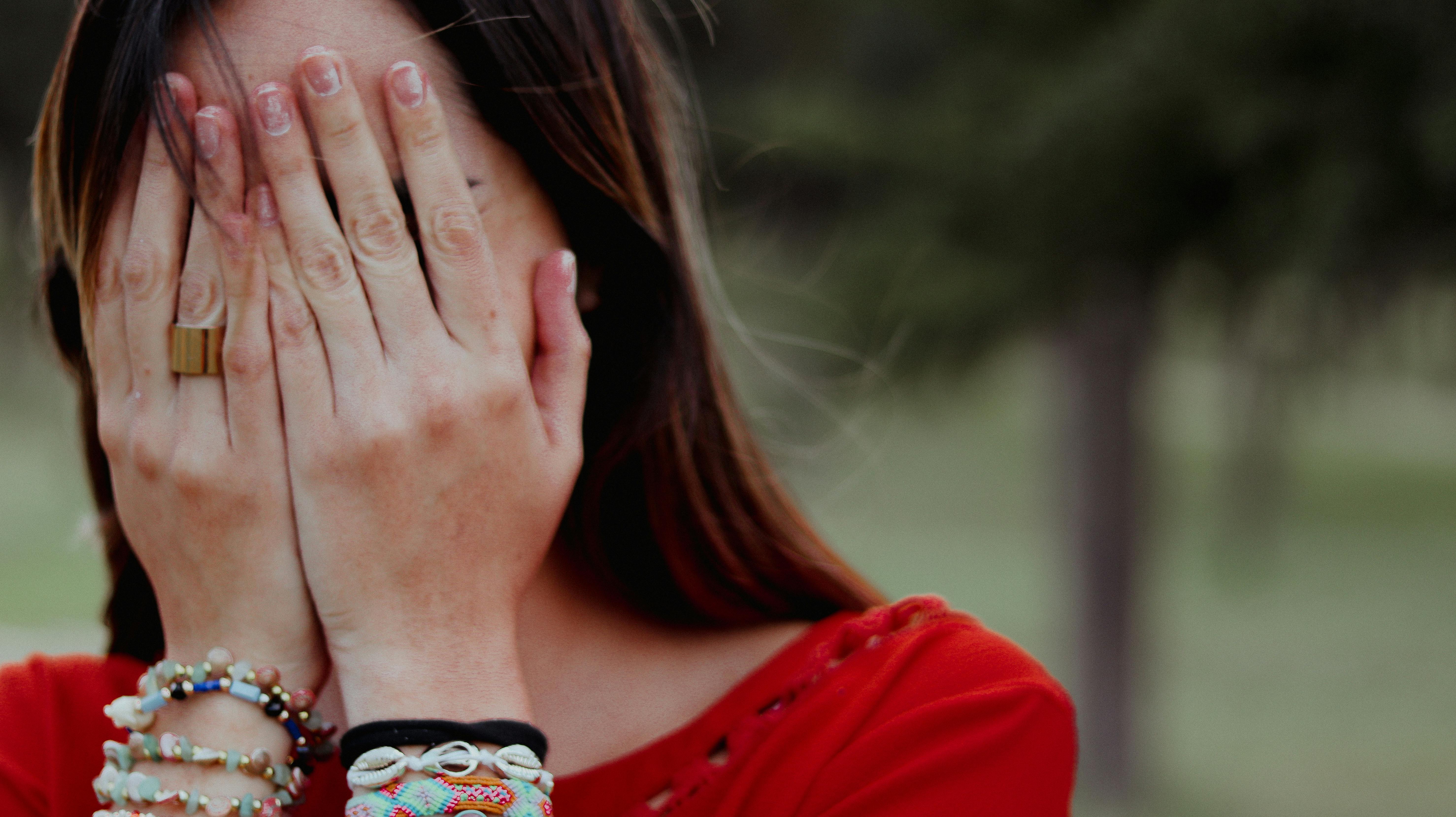 A woman covering her face with her palms | Source: Pexels