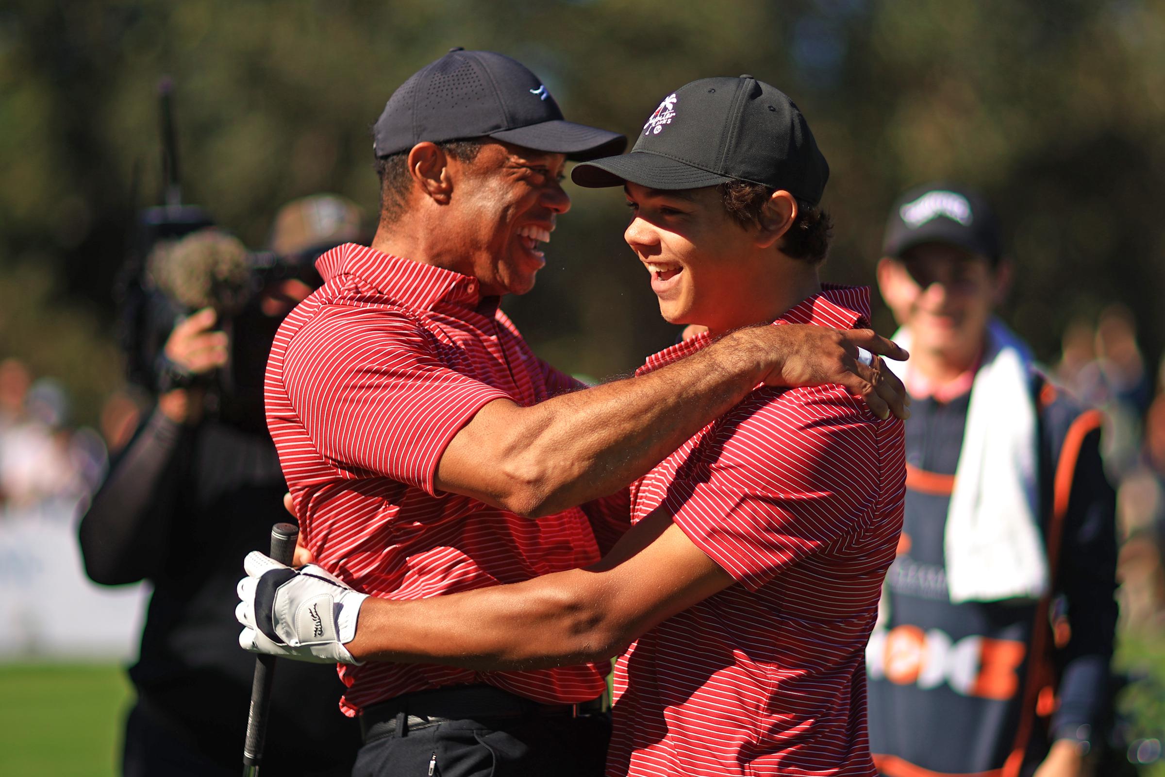 Tiger Woods celebrates with son Charlie Woods after hitting the first hole-in-one of his career during Round 2 of the PNC Championship in Orlando on December 22, 2024.
