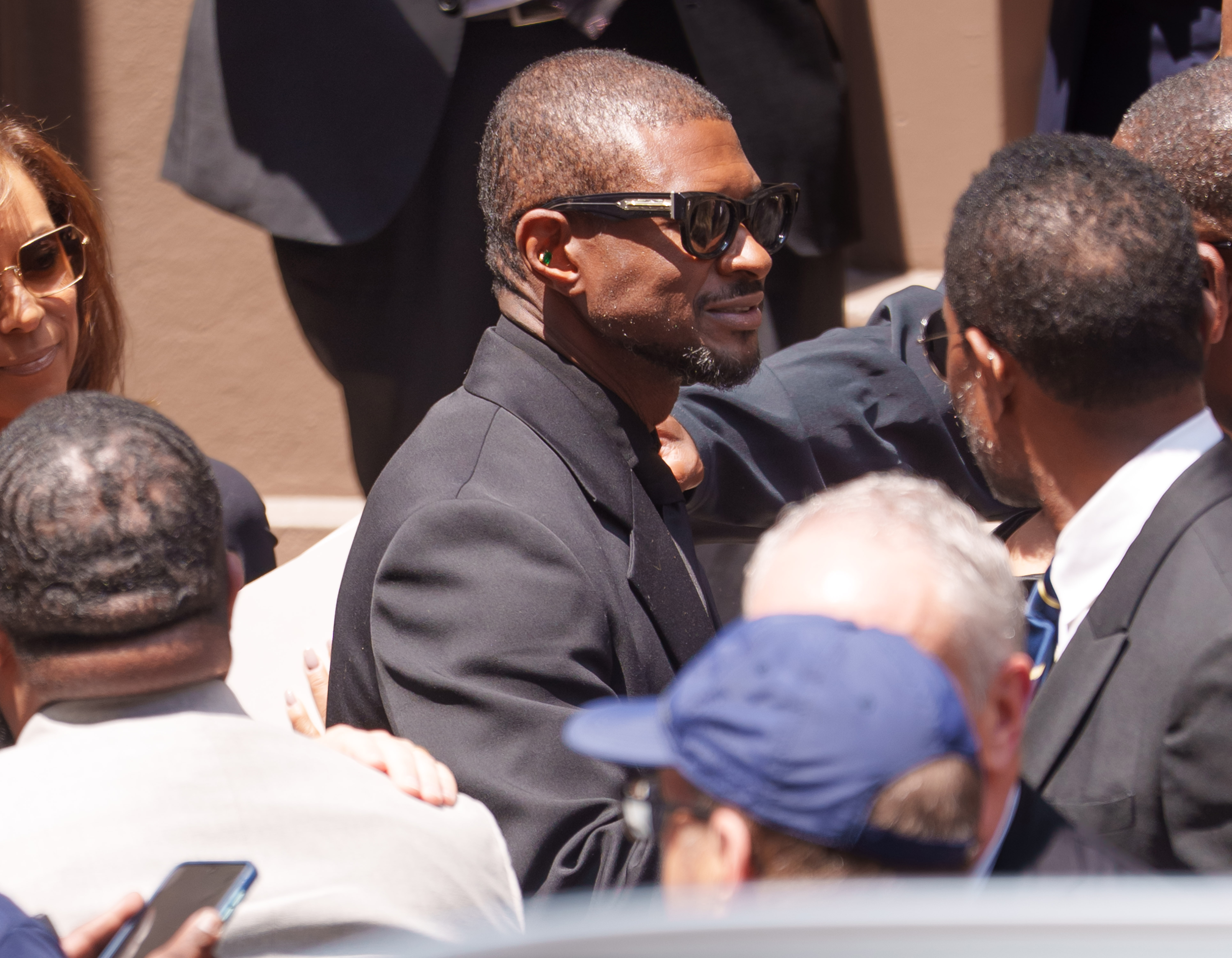 Netizens weren't sure what to think when they saw Usher smiling outside of the synagogue. | Source: Getty Images