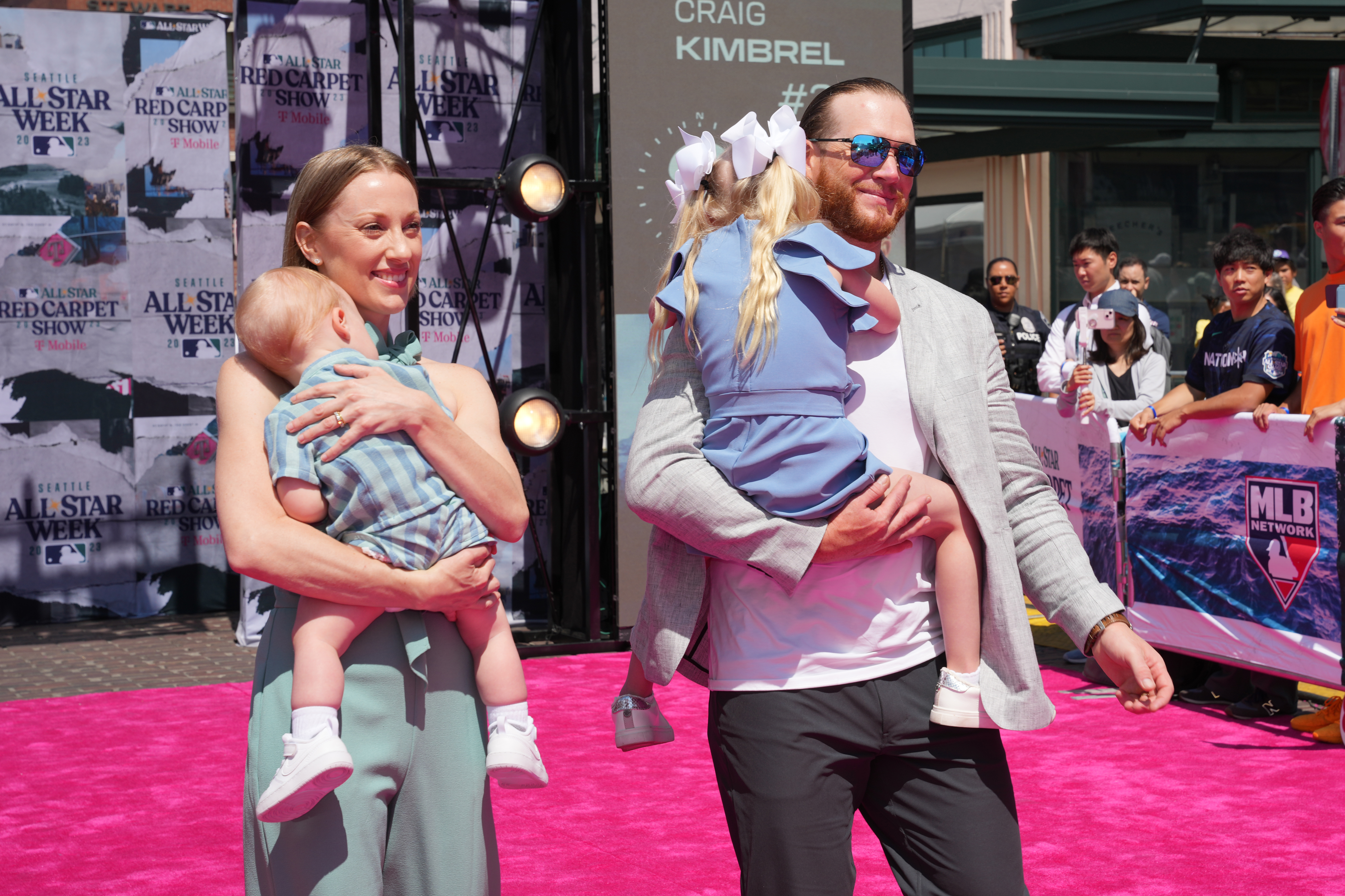 Ashley Holt Kimbrel carries Son Joseph and Craig Kimbrel carries daughter Lydia Joy as they walk during the All-Star Red Carpet Show at Pike Place Market on Tuesday, July 11, 2023, in Seattle, Washington. | Source: Getty Images