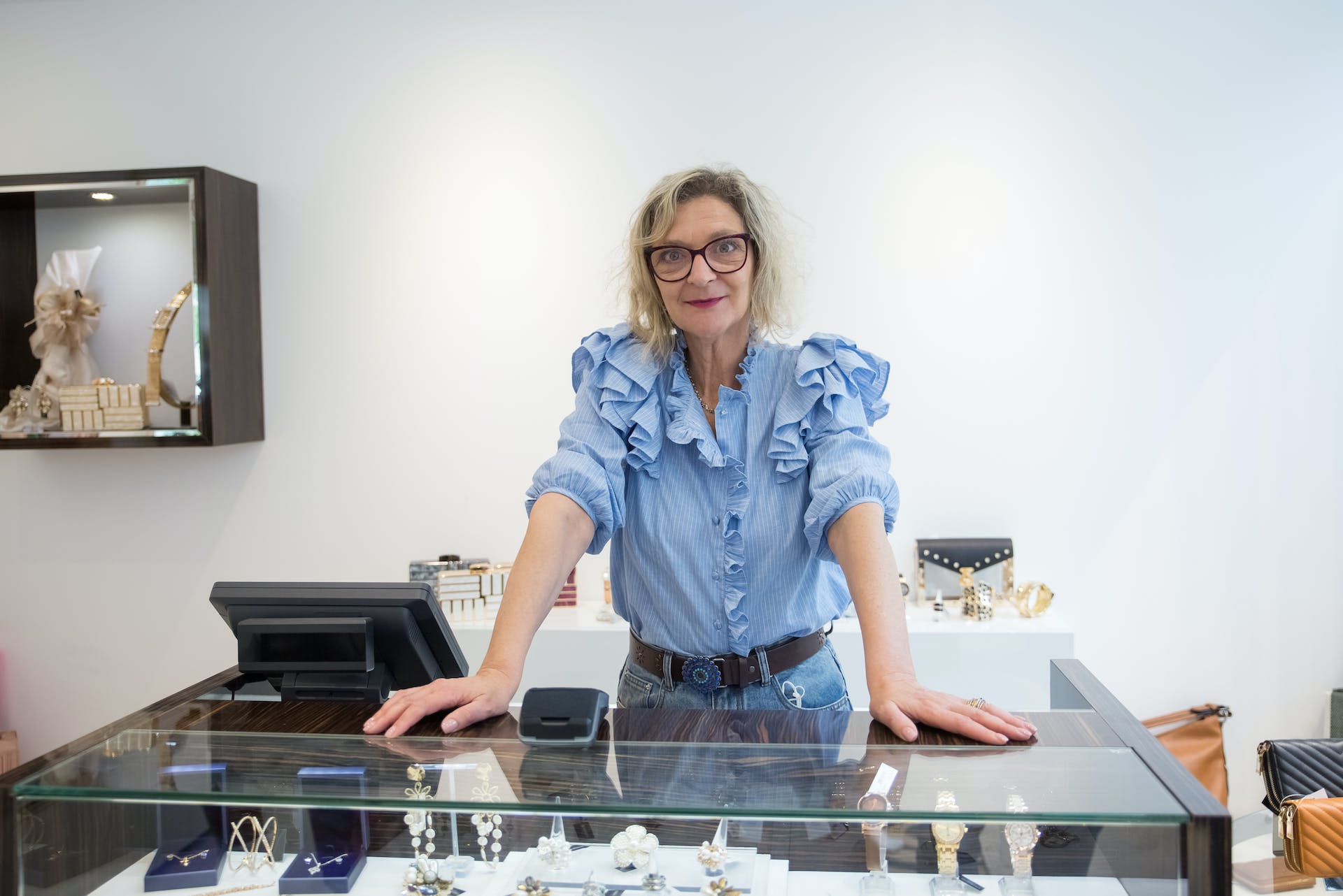 A woman standing at the counter of a jewelry store | Source: Pexels