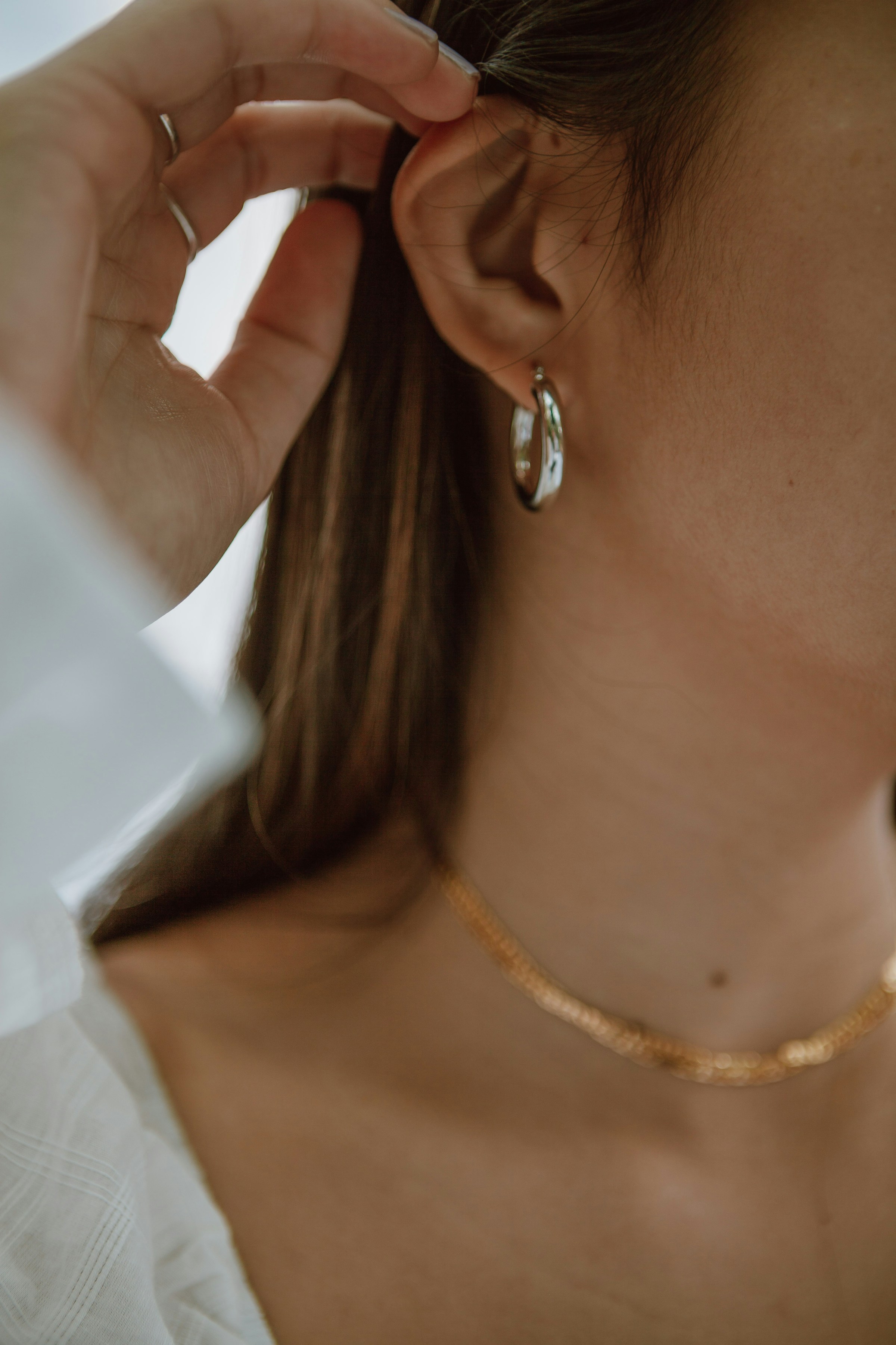 A woman showing off her earrings | Source: Unsplash
