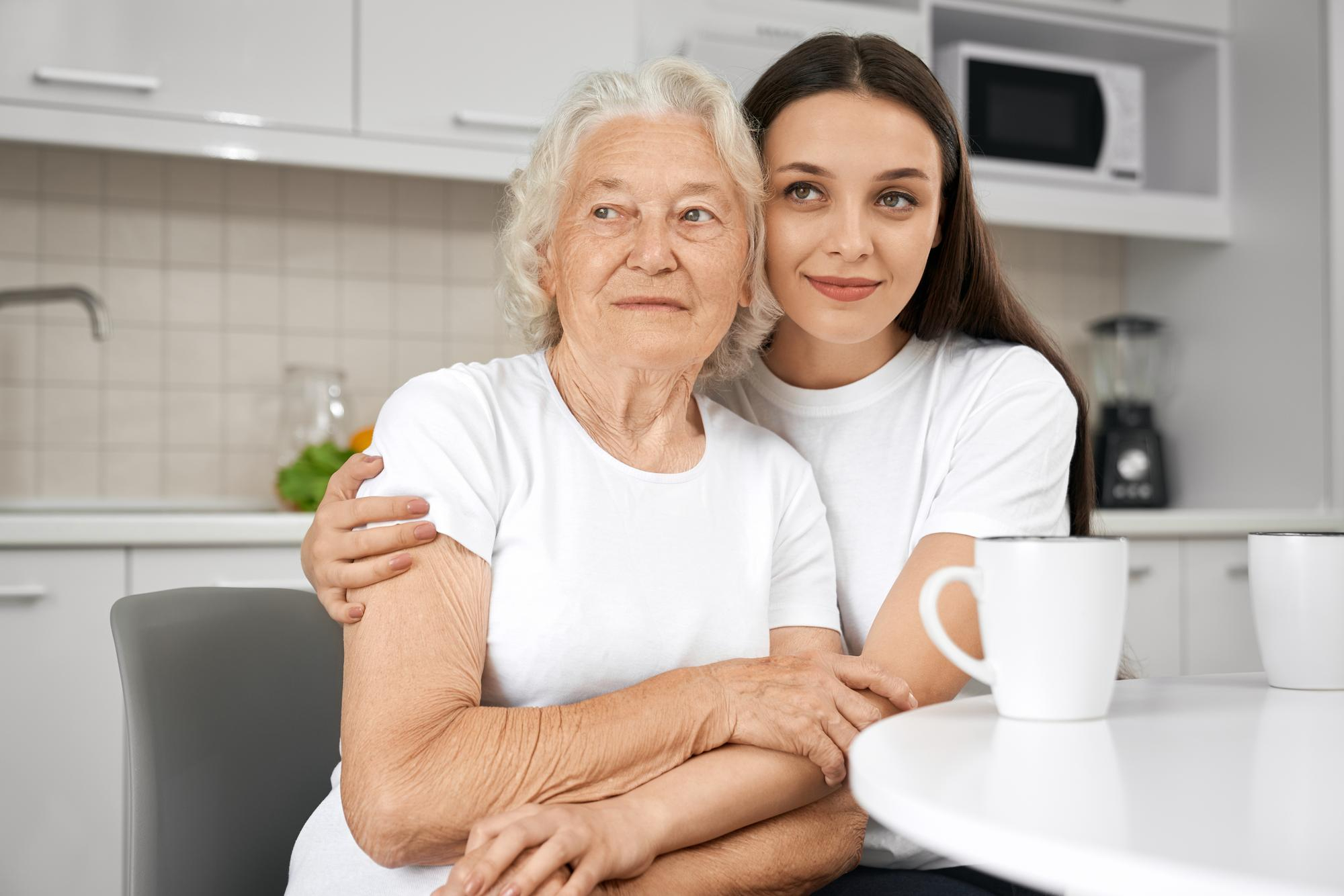 A senior woman is pictured hugging her daughter. | Source: freepik/ArtPhoto_studio