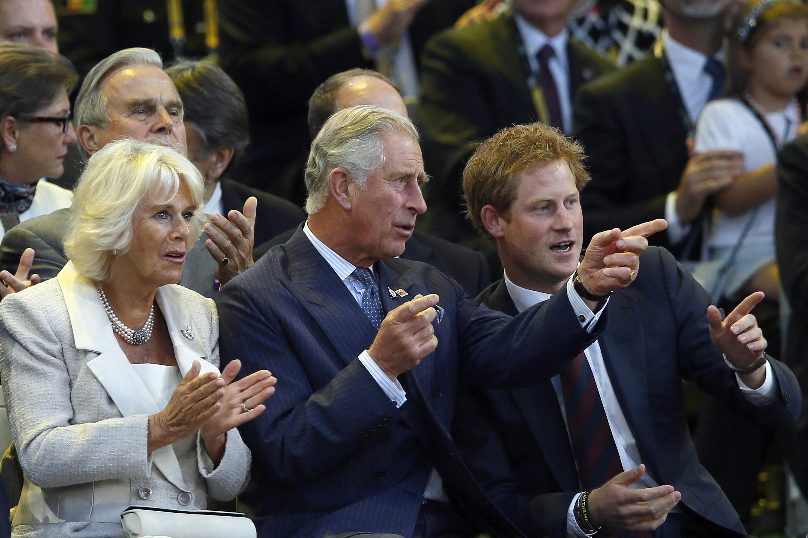 Prince Charles sits next to his wife Camilla and his son Prince Harry during the opening ceremony of the Invictus Games at Queen Elizabeth II Park in London on September 10, 2014 | Source: Getty Images
