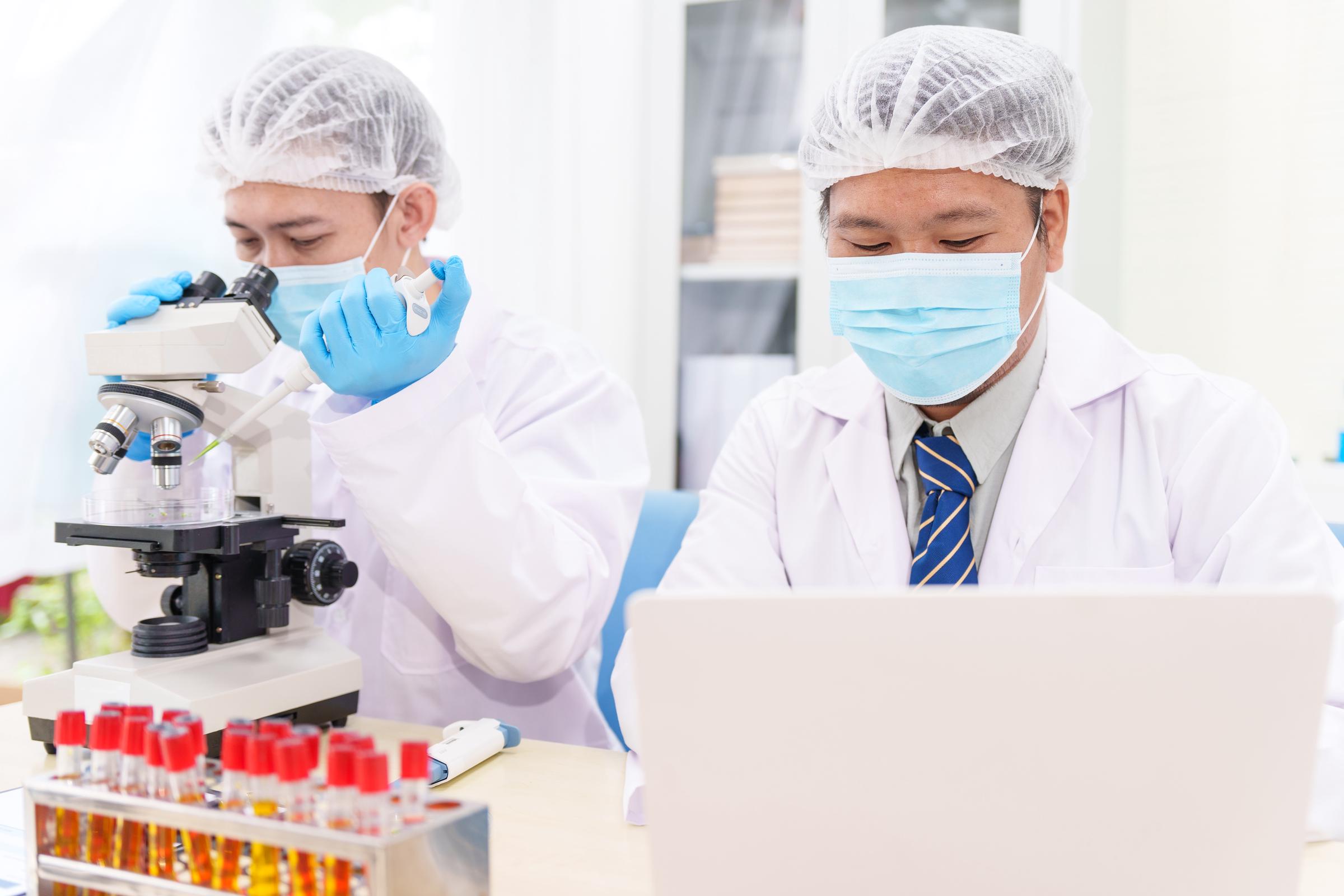 Scientists in lab coats, carrying out a study | Source: Getty Images