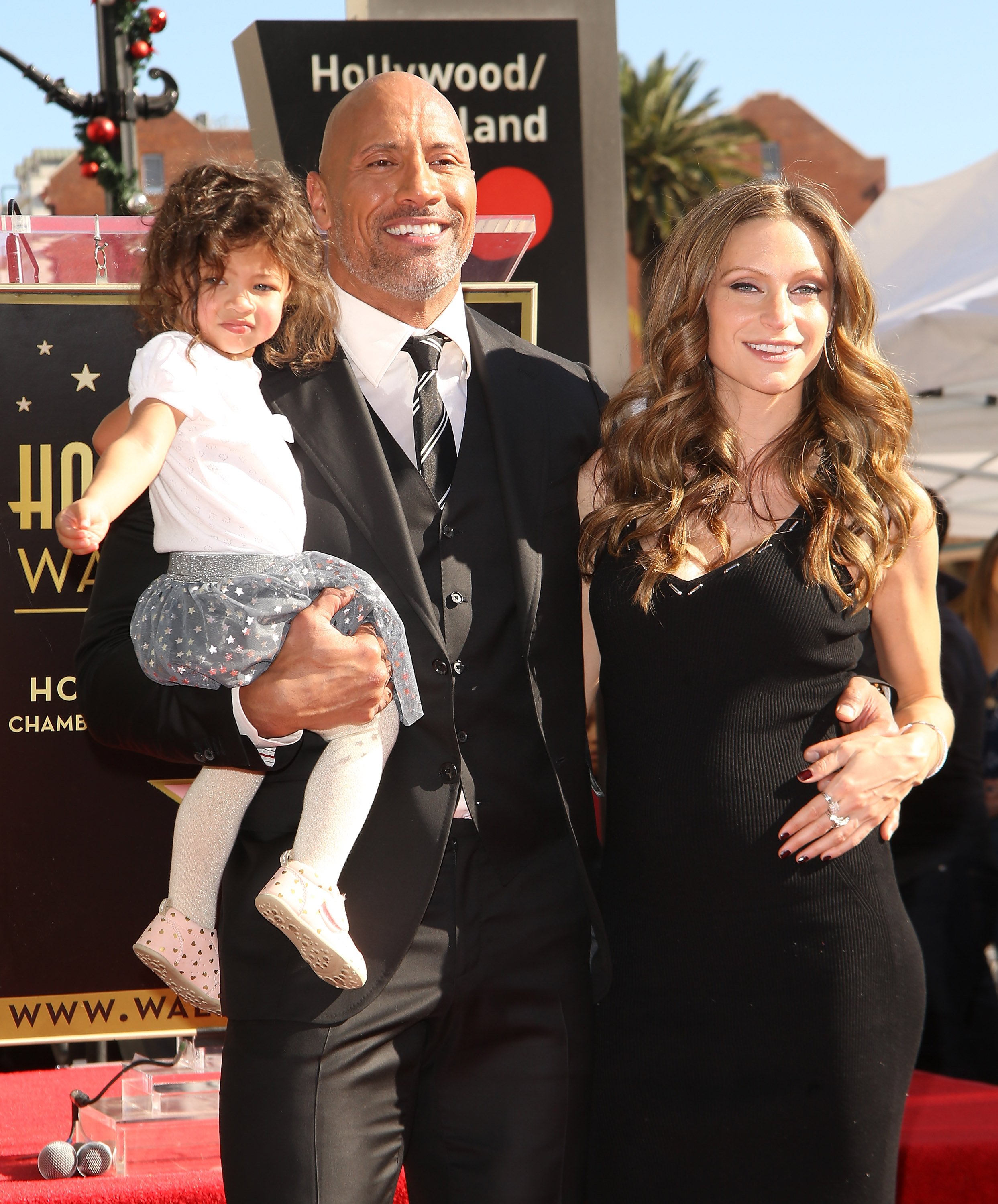 Dwayne Johnson, a pregnant Lauren Hashian, and their daughter Jasmine Johnson at the ceremony honoring him with a star on the Hollywood Walk of Fame on December 13, 2017, in Hollywood, California | Source: Getty Images