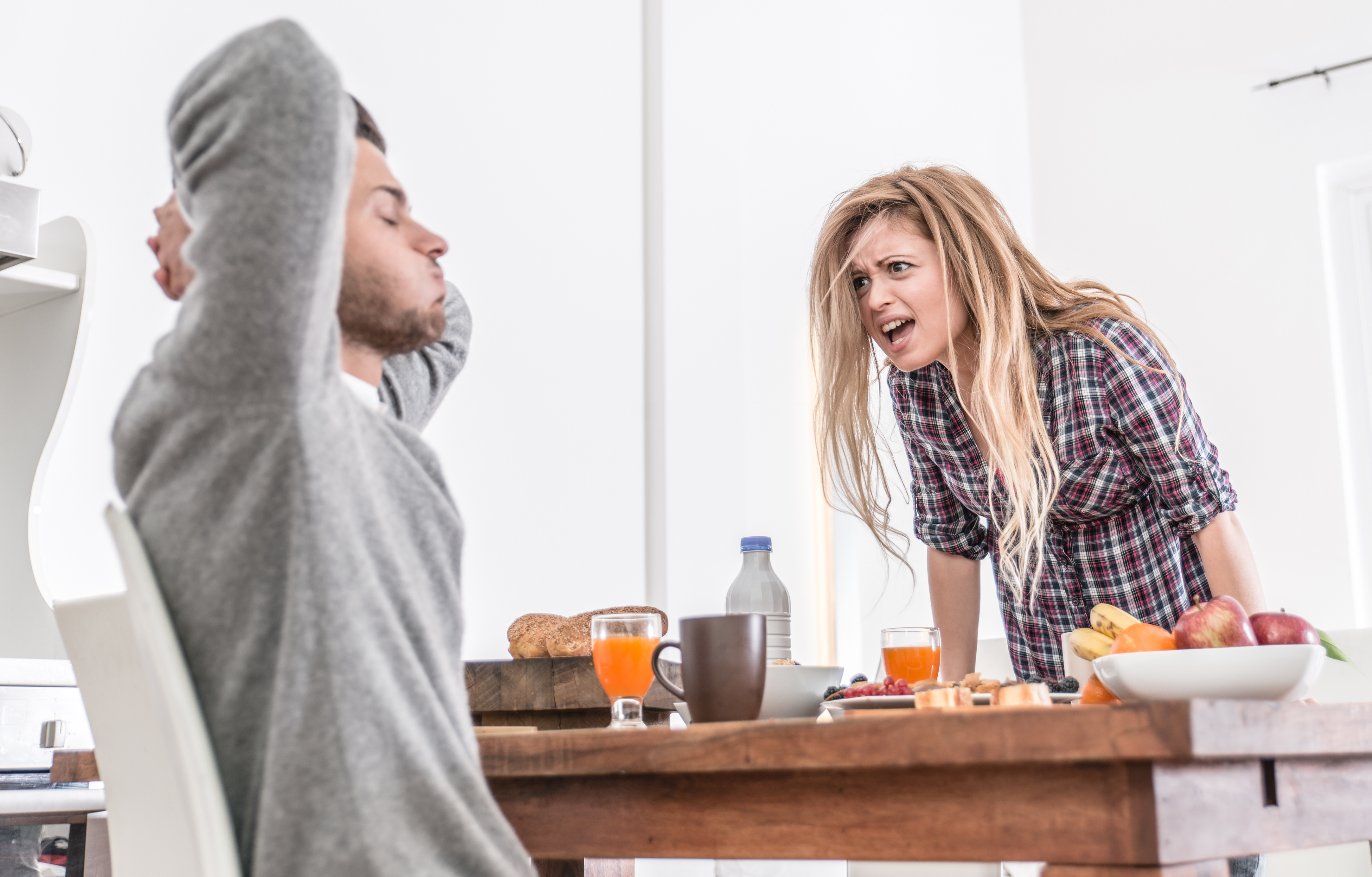 Couple arguing in a kitchen | Source: Shutterstock