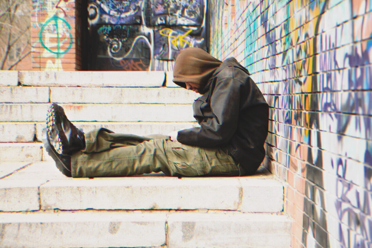 Homeless man sitting on the street | Source: Shutterstock