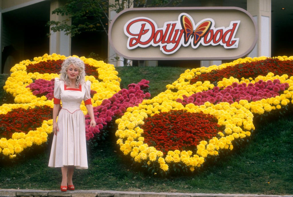 Dolly Parton posing for photos in front of her amusement park, Dollywood, in Knoxville-Smoky Mountains metroplex, Pigeon Forge, Tennessee, on October 24, 1988. | Photo: Getty Images