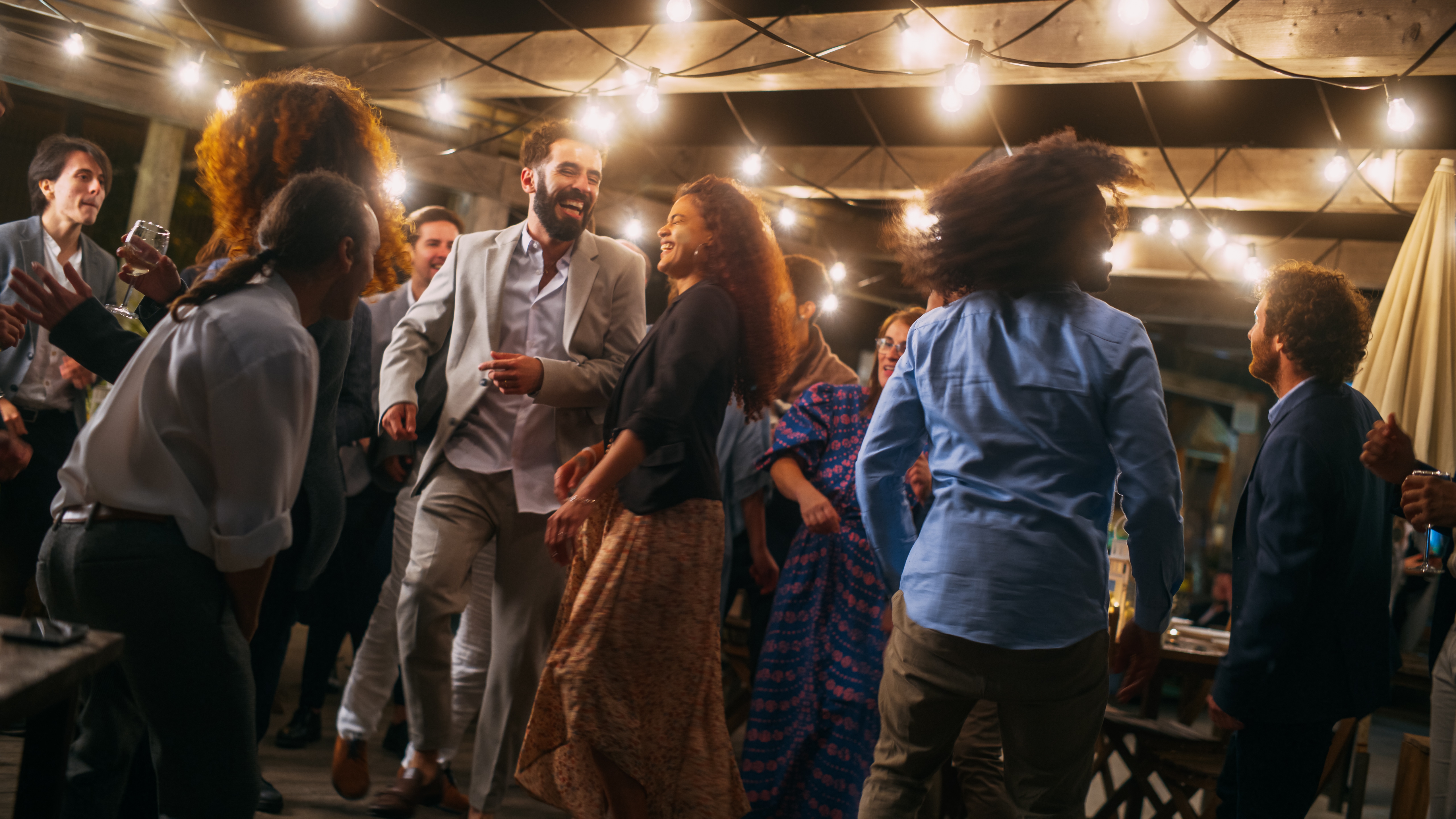 People are seen dancing together at a wedding reception | Source: Shutterstock