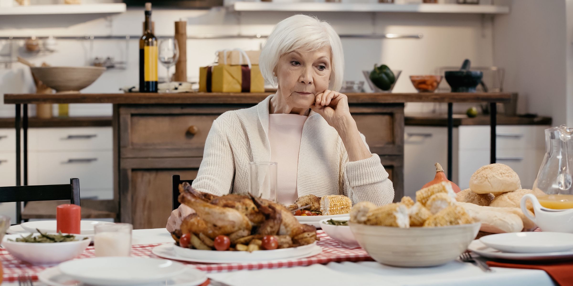 An older woman sitting at the dinner table | Source: Shutterstock