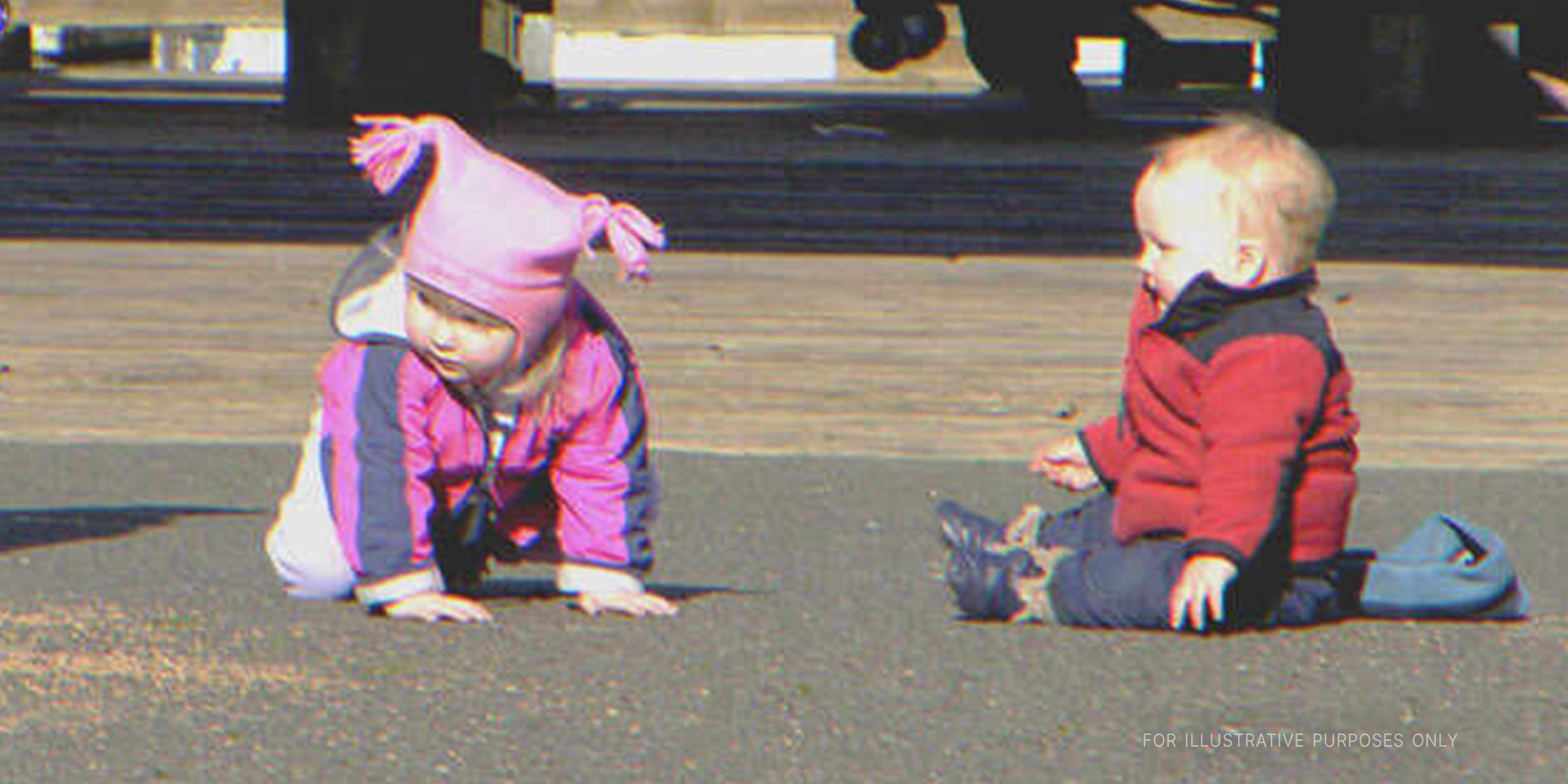 Two babies sitting on pavement. | Flickr / Laurel Fan (CC BY-SA 2.0)