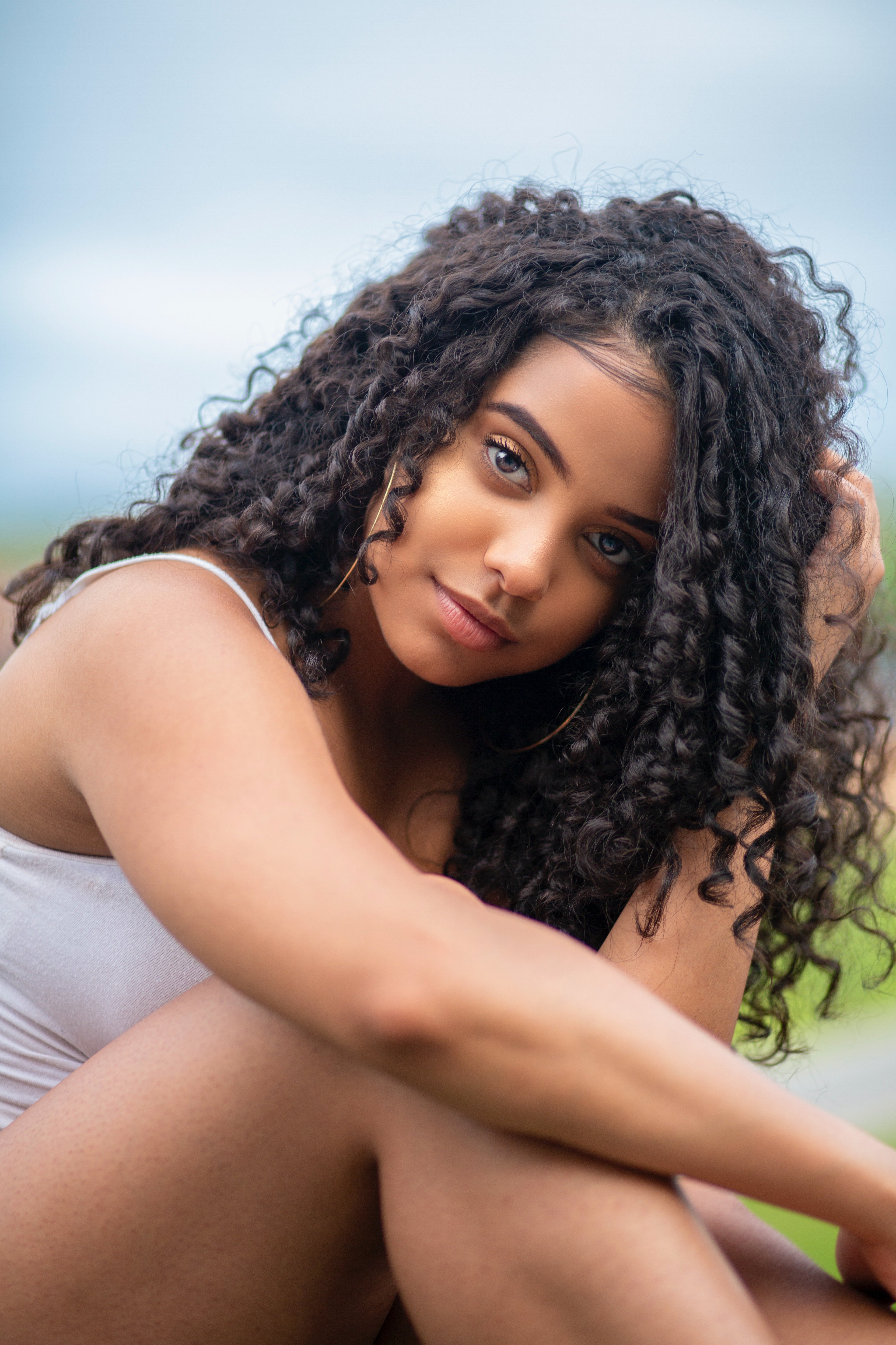 Une jeune femme aux magnifiques cheveux bouclés. l Source : Pexels