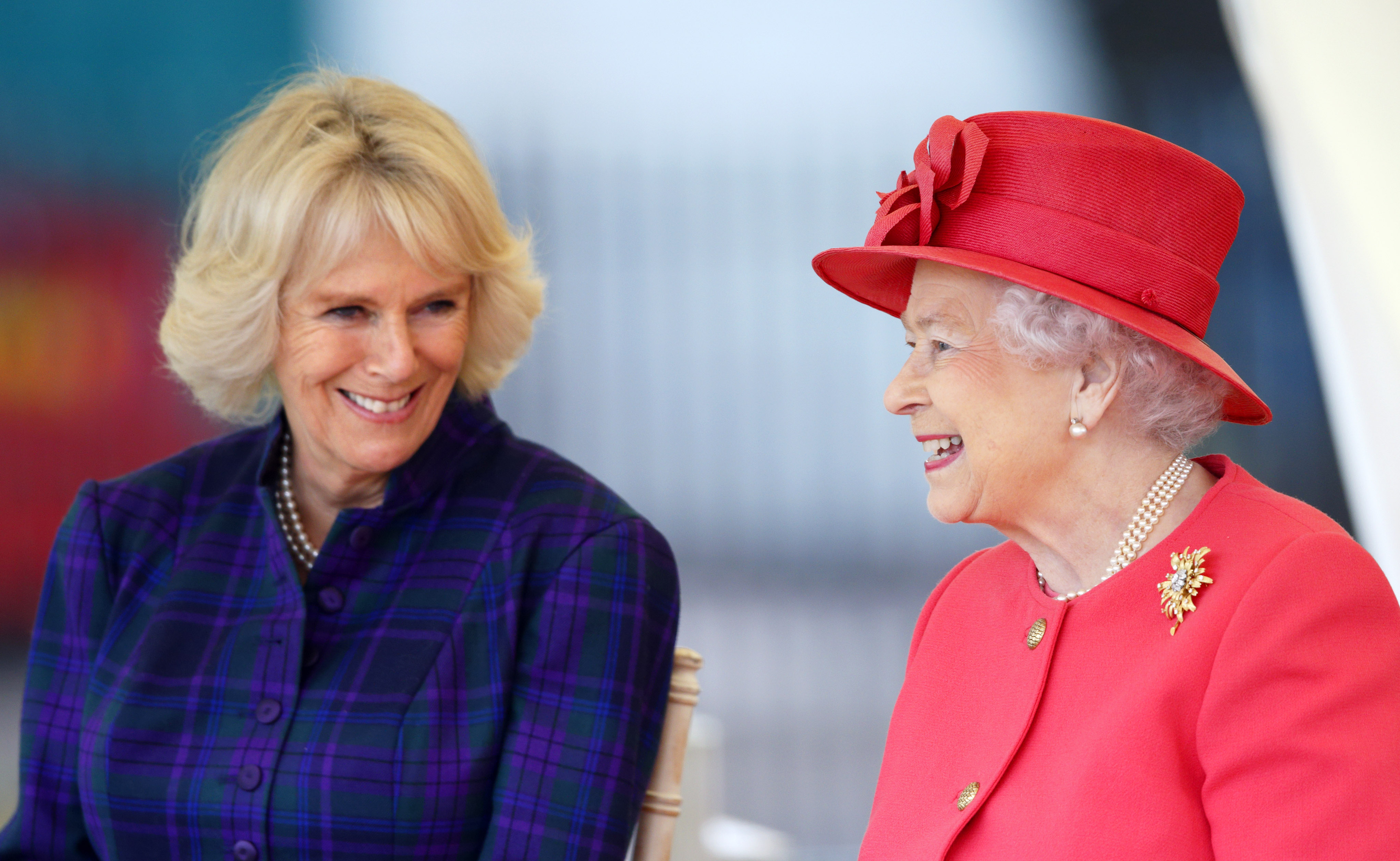 Queen Camilla and Queen Elizabeth II during their visit to the Ebony Horse Club and Community Riding Centre in London, England on October 29, 2013 | Source: Getty Images