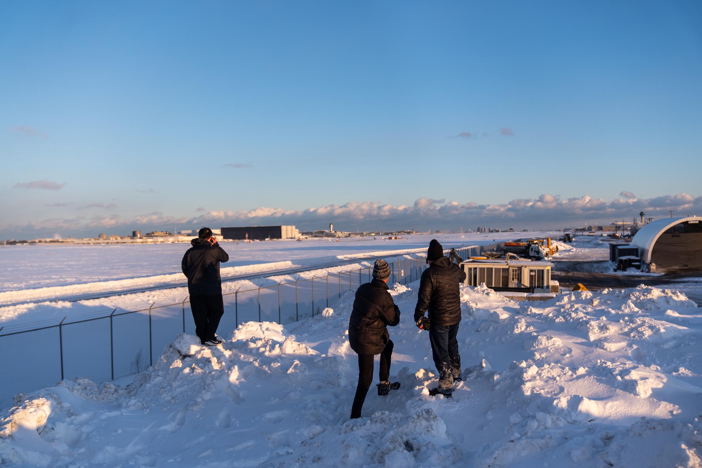 Bystanders look over the scene of a Delta Airlines plane crash on February 17, 2025, in Toronto, Canada. | Source: Getty Images