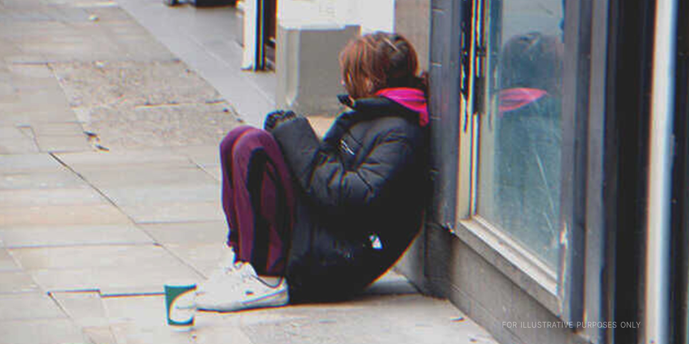 Girl sitting alone on the street | Source: Shutterstock