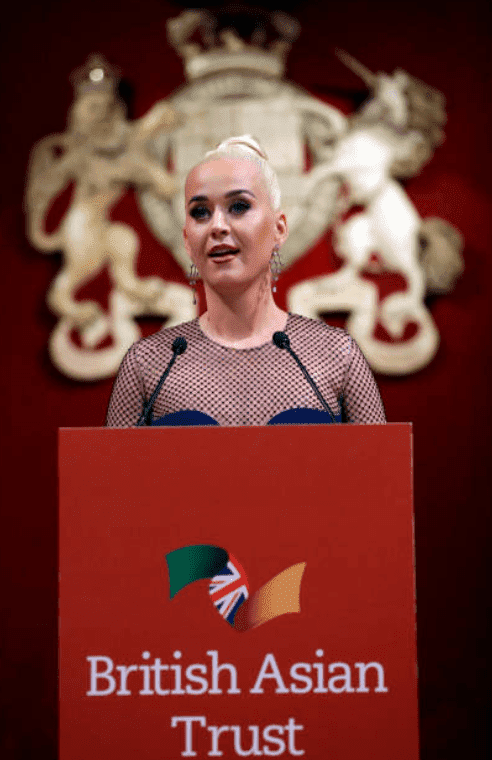 Katy Perry stand at a podium as she says a speech during the reception for the British Asian Trust, on February 4, 2020, in London, England | Source: Kirsty Wigglesworth - WPA Pool/ Getty Images