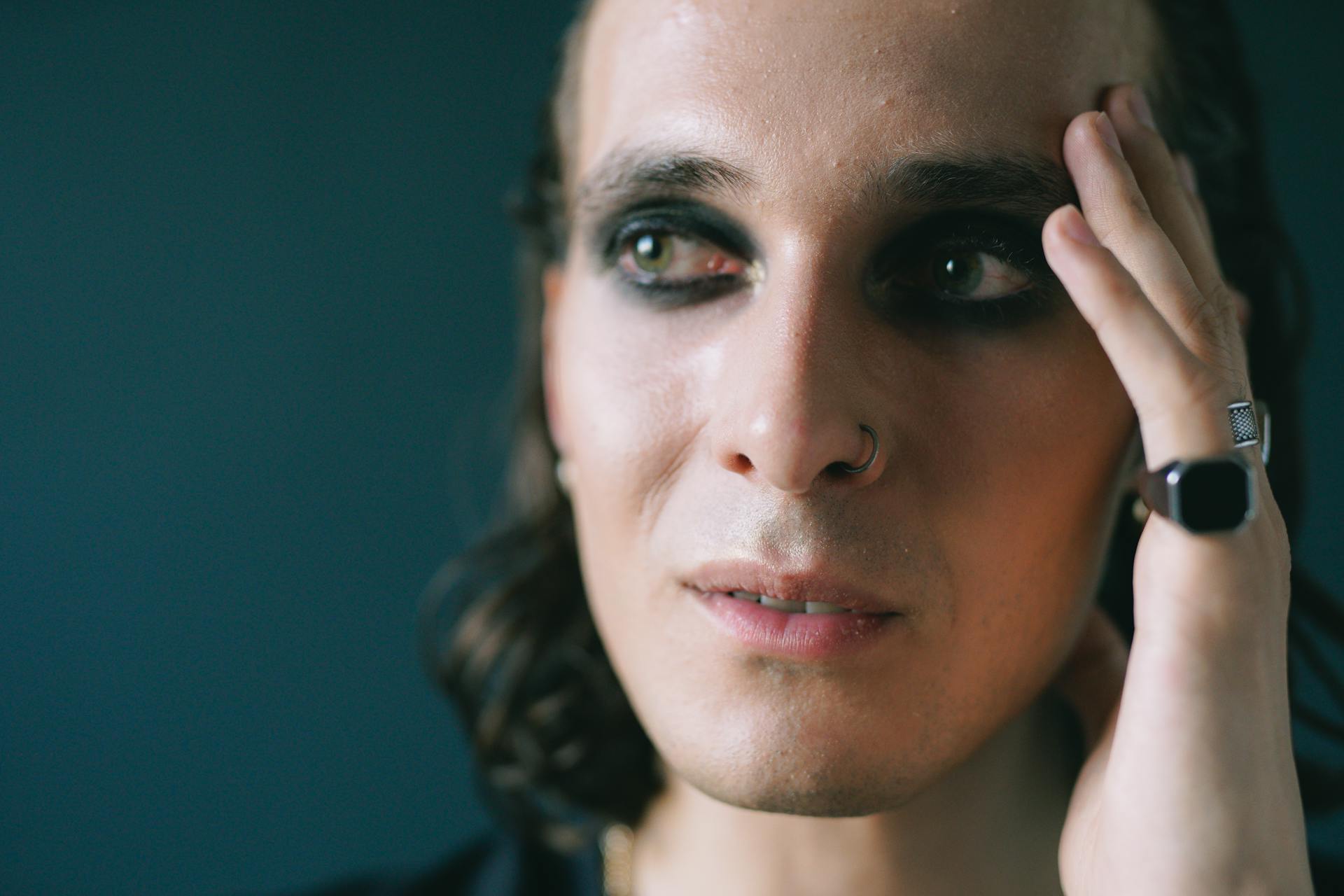 A man wearing makeup looking at someone | Source: Pexels