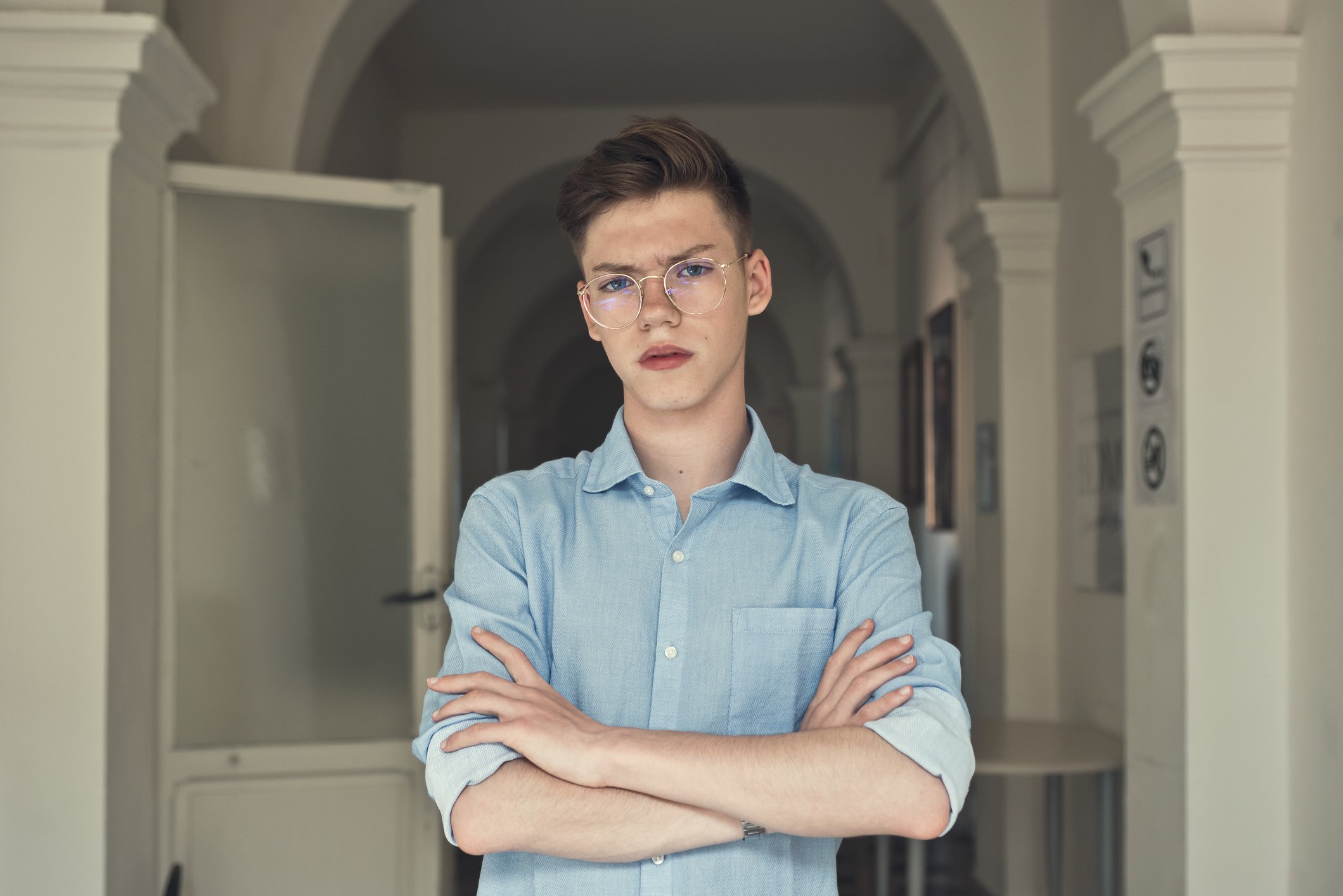 A portrait of an angry teen wearing glasses. | Photo: Getty Images