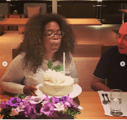 Oprah blowing out her birthday candles | Instagram: @gayleking