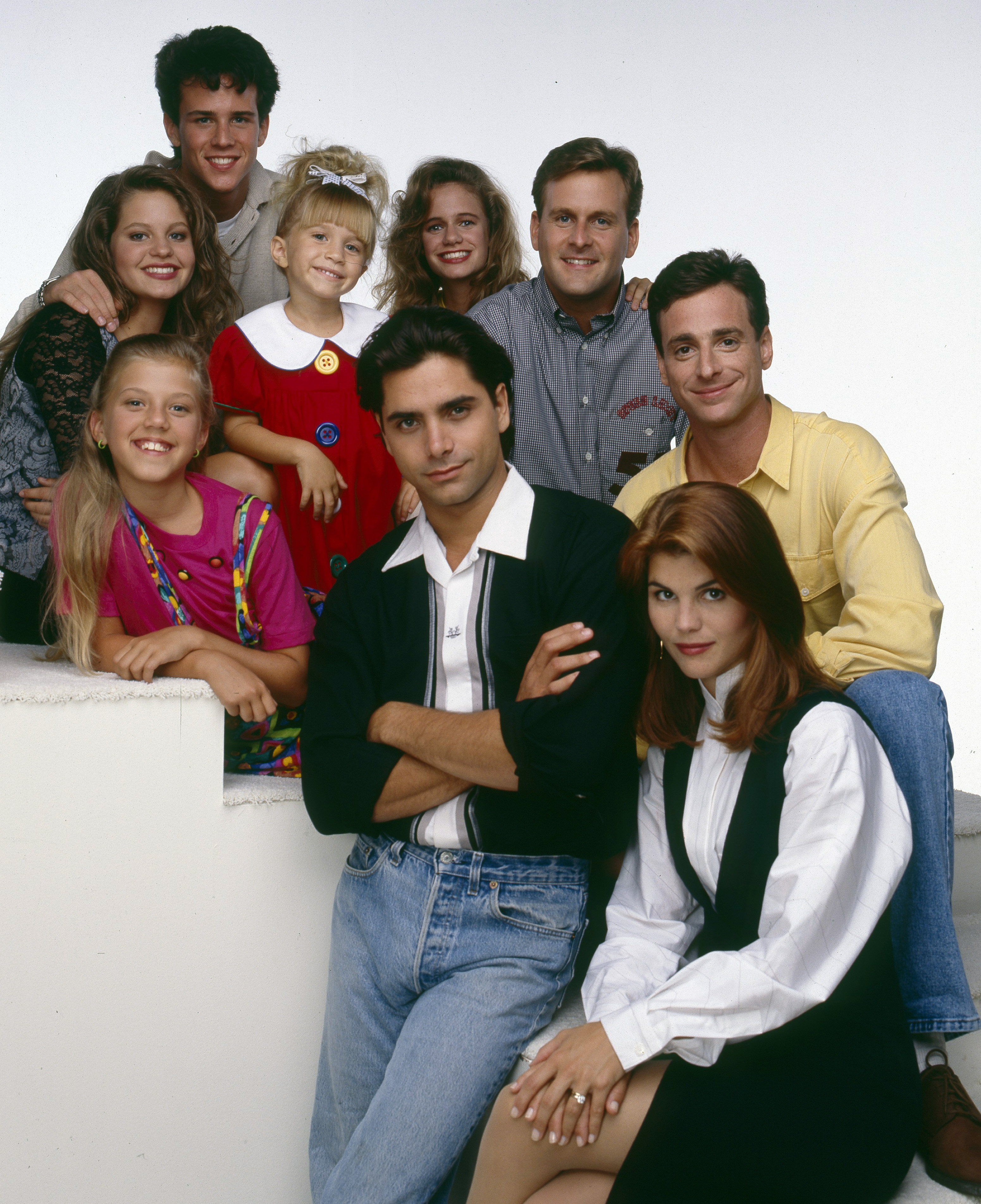 (Not in order) Jodie Sweetin, Mary-Kate / Ashley Olsen, Bob Saget, Candace Cameron Burke, Dave Coulier, John Stamos, Lori Loughlin, Scott Weinger, and Andrea Barber pose for a promotional photo for "Full House" on August 30, 1993 | Source: Getty Images