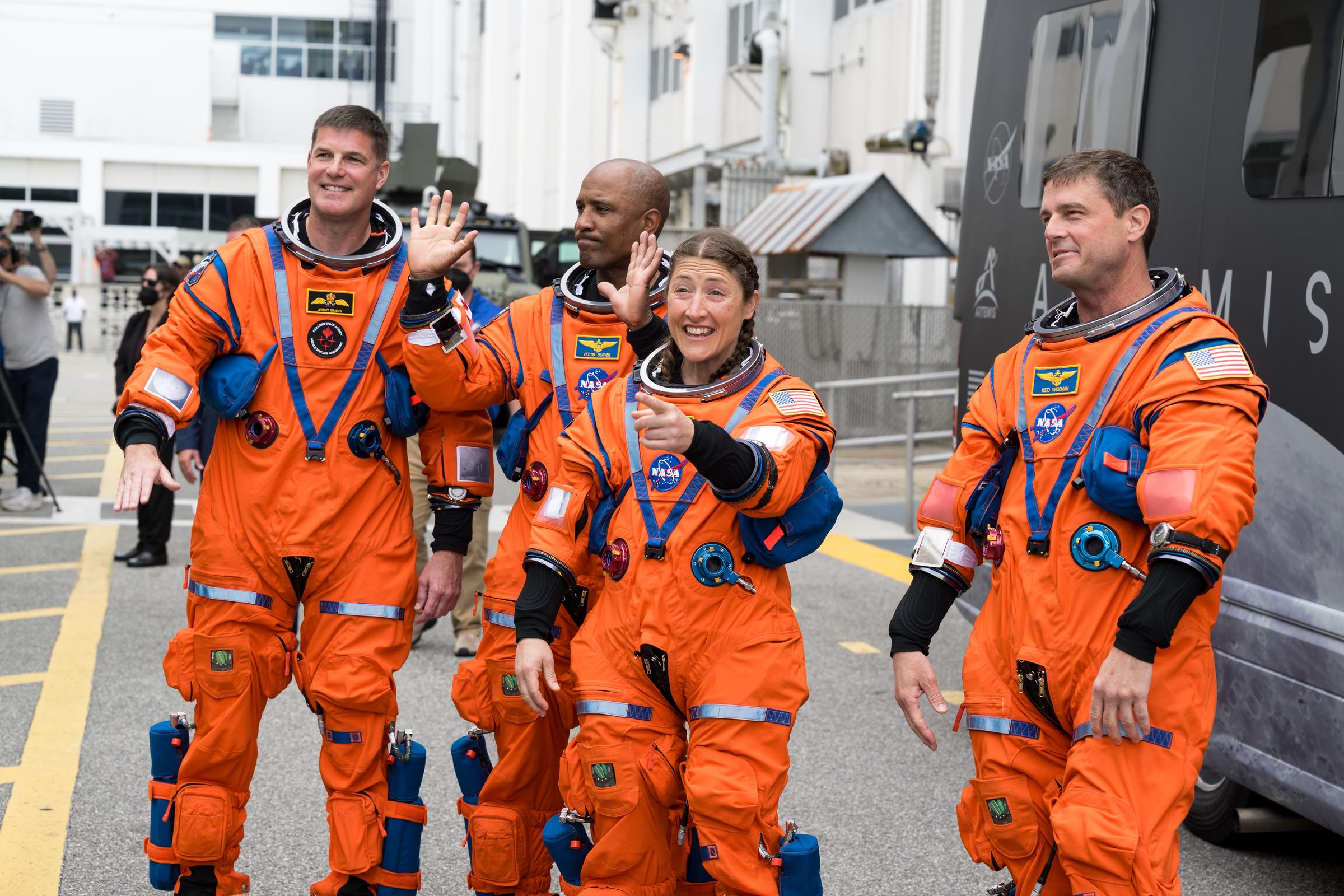 NASA astronauts Reid Wiseman, commander; Christina Koch and Jeremy Hansen, mission specialists; and Victor Glover, pilot, wave to family and friends before leaving the Neil A. Armstrong Operations and Checkout Building to board the Orion spacecraft. | Source: Getty Images