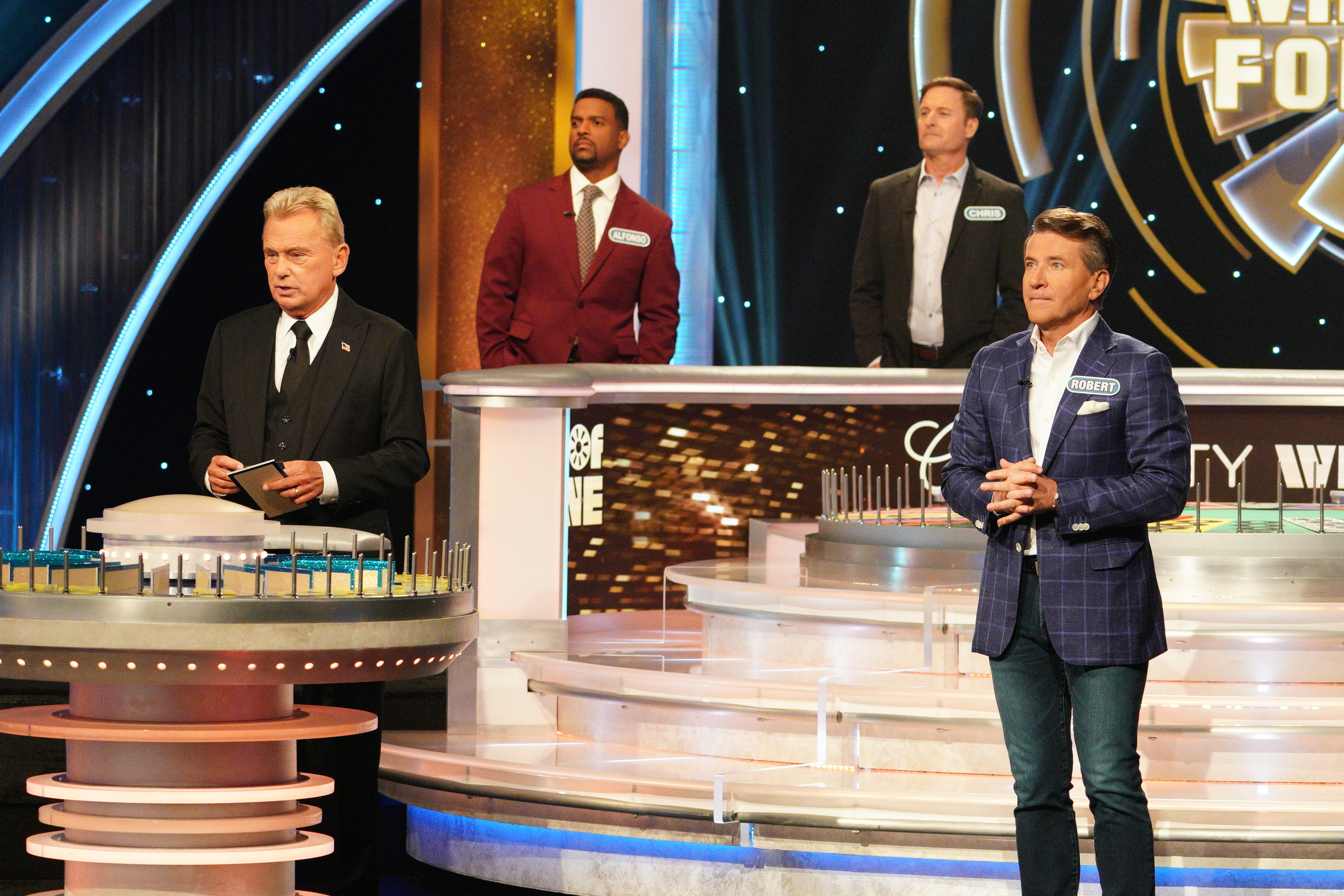 The TV host with Robert Herjavec, Chris Harrison, and Alfonso Ribeiro, on the iconic game show "Wheel of Fortune" in December 2020 | Source: Getty Images