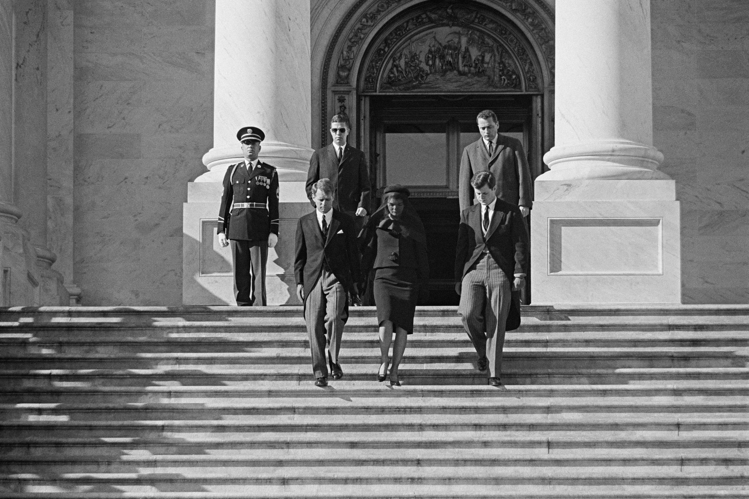 Robert Kennedy (L) and Edward Kennedy (R), brothers of US slain President John Fitzgerald Kennedy, and his widow US First Lady Jacqueline Kennedy walk down the steps from St. Matthews Cathedral in Washington, D.C., on November 25, 1963, during Kennedy's state funeral. | Source: Getty Images