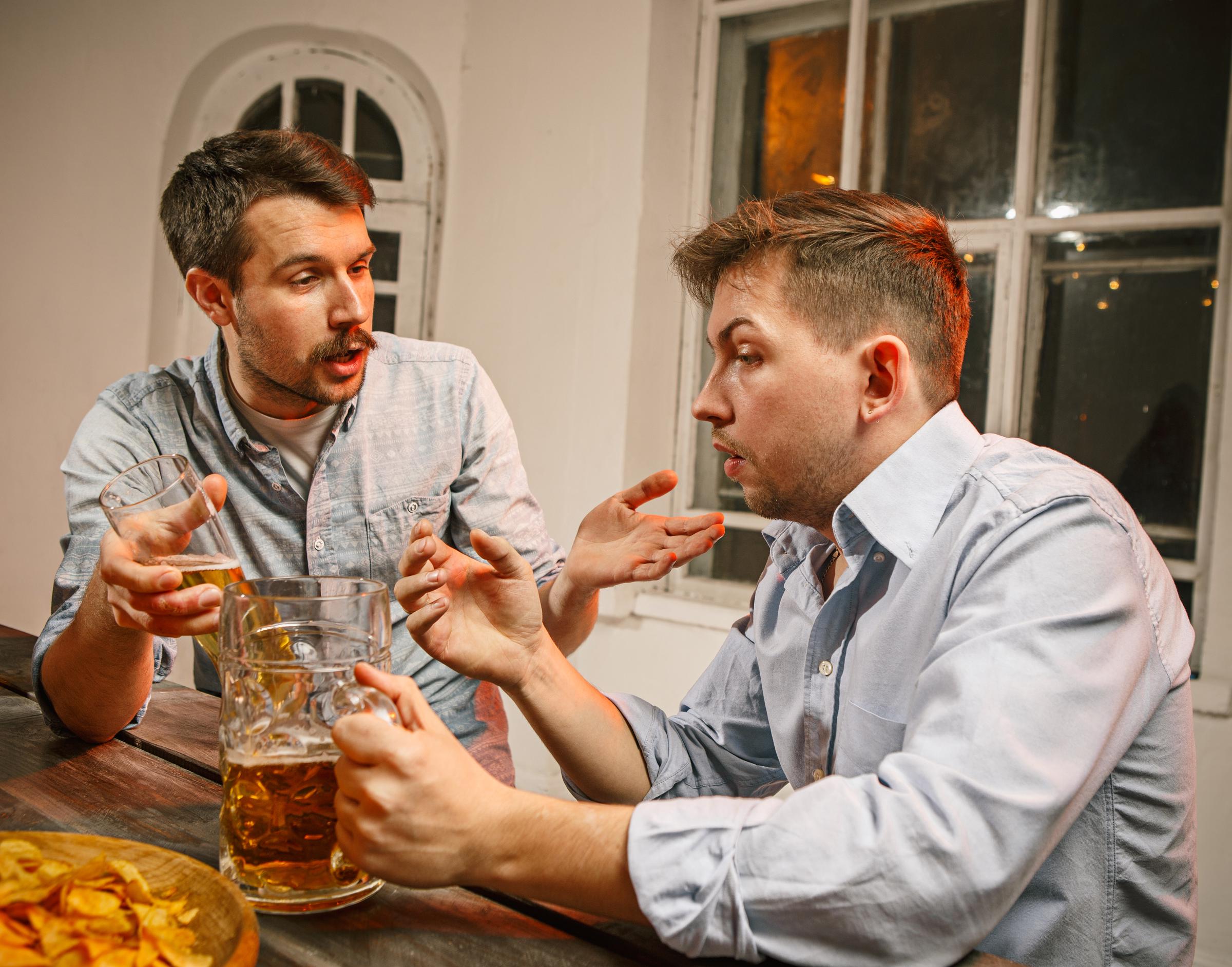 Two men drinking beer | Source: Freepik