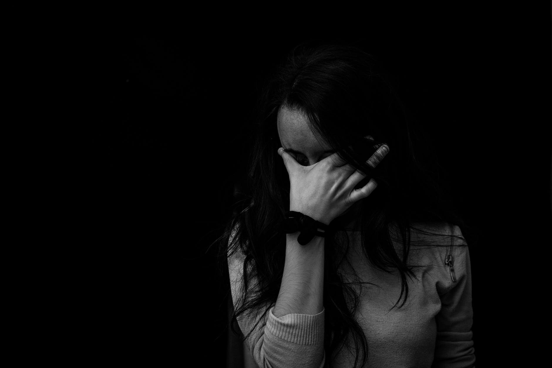 A black-and-white portrait of a sad woman crying after receiving bad news. | Photo: Pexels
