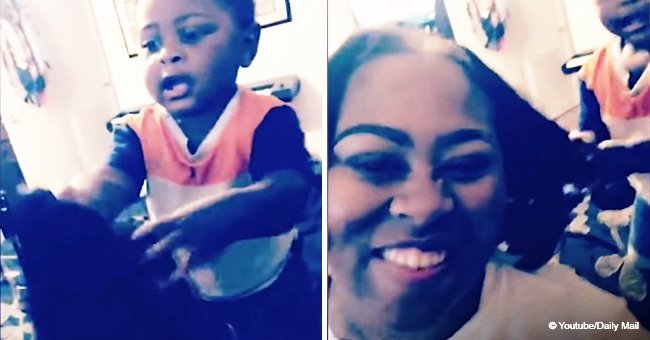 Toddler hilariously freezes in horror after accidentally pulling his mother's wig off