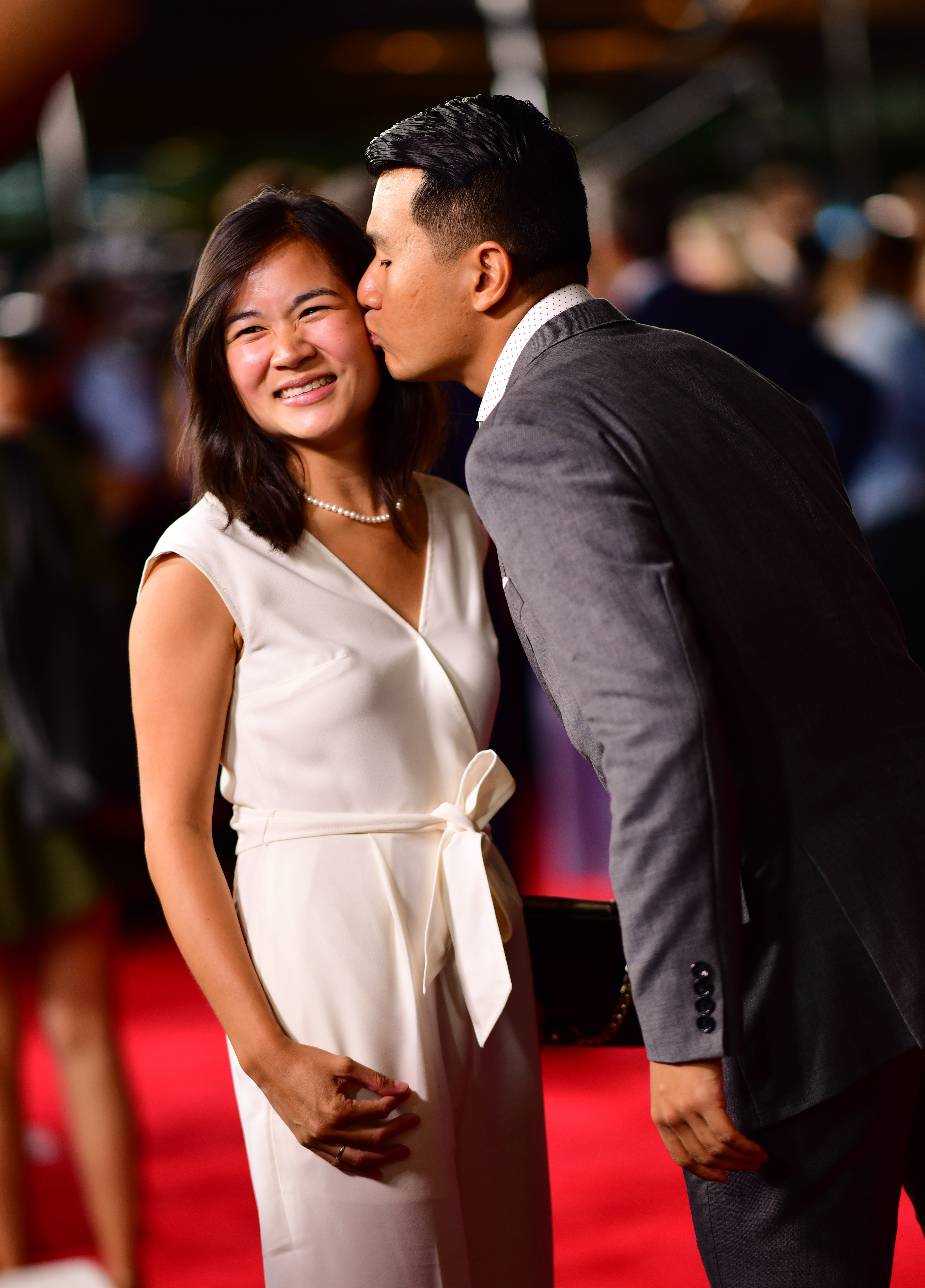 Hannah Pham and Ronny Chieng kissing at the "Mission Impossible: Fallout" Premiere at the Smithsonian National Air & Space Museum on July 22, 2018, in Washington, D.C. | Source: Getty Images