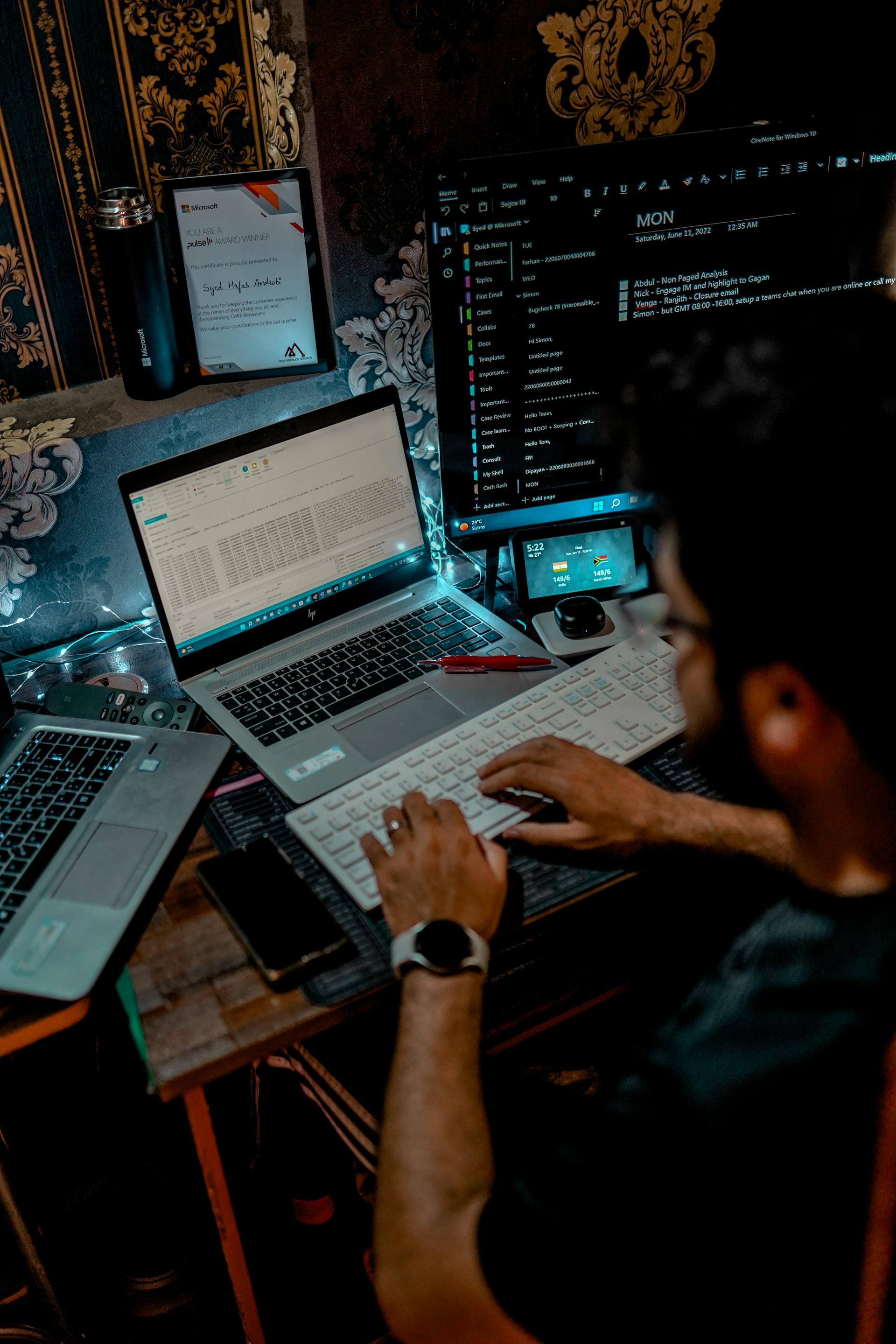 A man working on a computer keyboard in front of a laptop | Source: Pexels