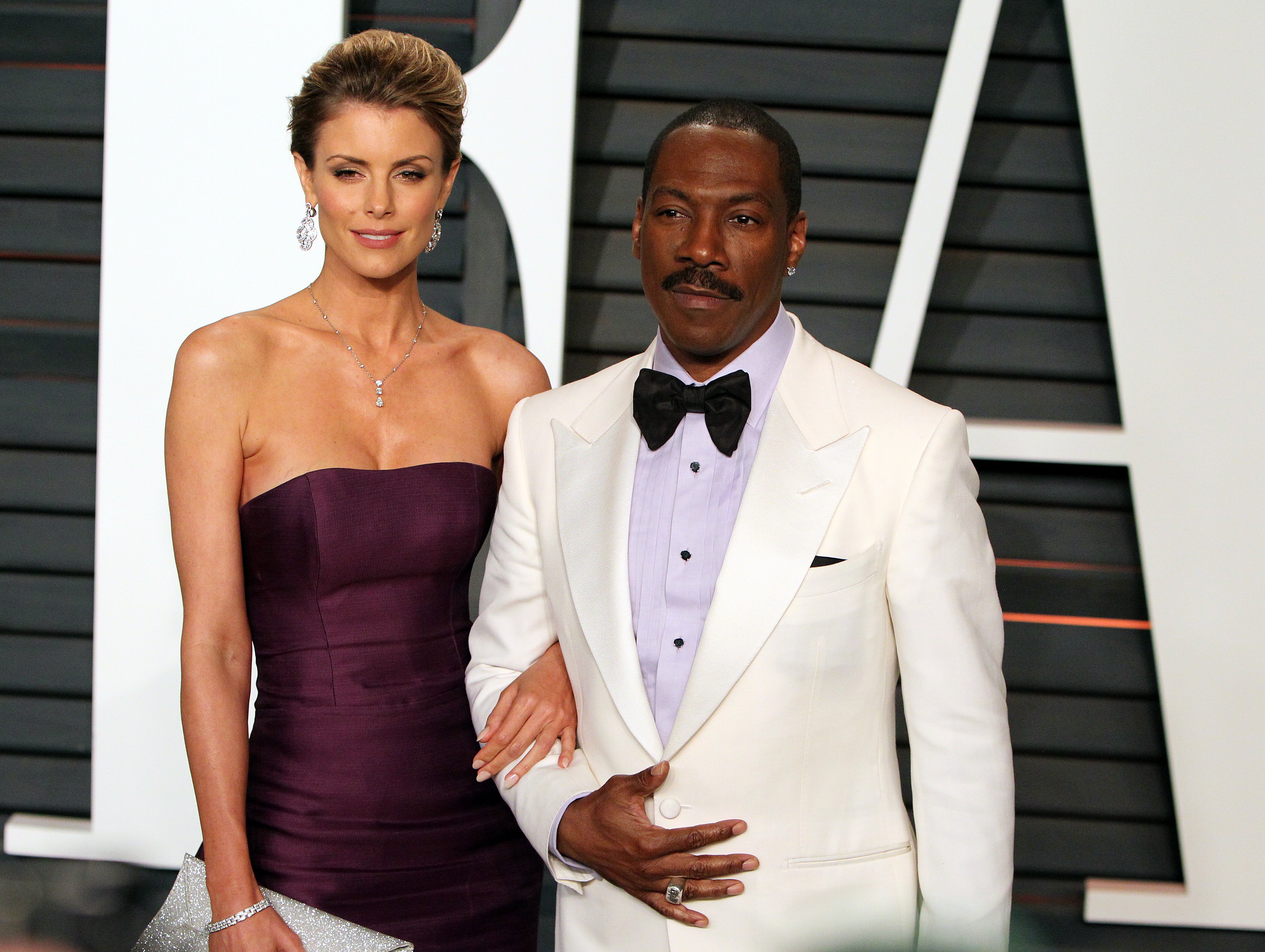 Paige Butcher and Eddie Murphy at the Vanity Fair post-Oscar party in Beverly Hills, California, on February 22, 2015. | Source: Getty Images