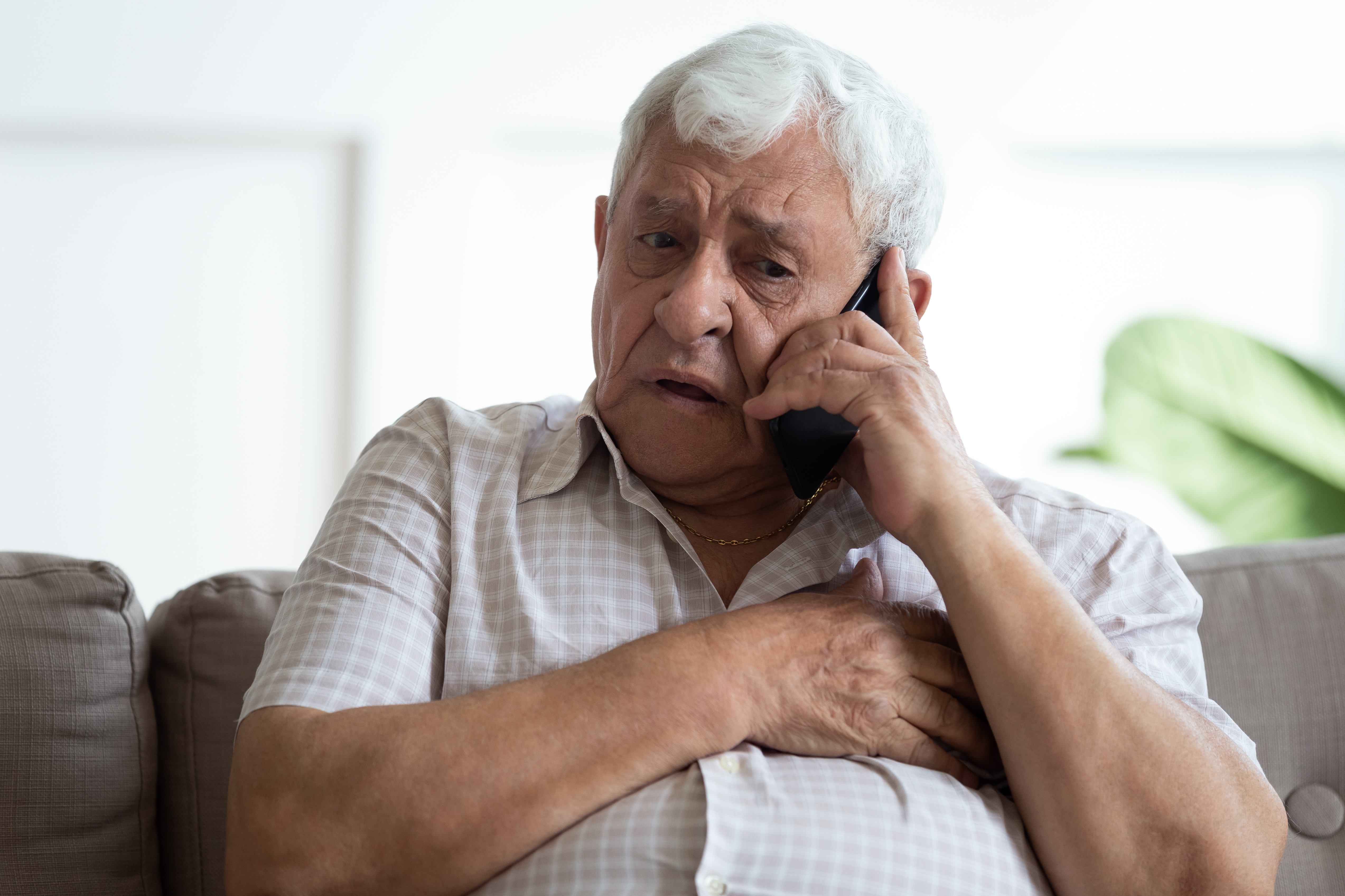 An elderly man on the phone | Source: Shutterstock