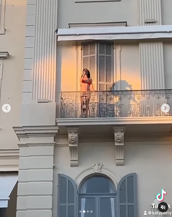 Katy Perry is seen wearing a bikini as she stands on the balcony with a drink, as shown in her Instagram post dated June 2024. | Source: Instagram/katyperry