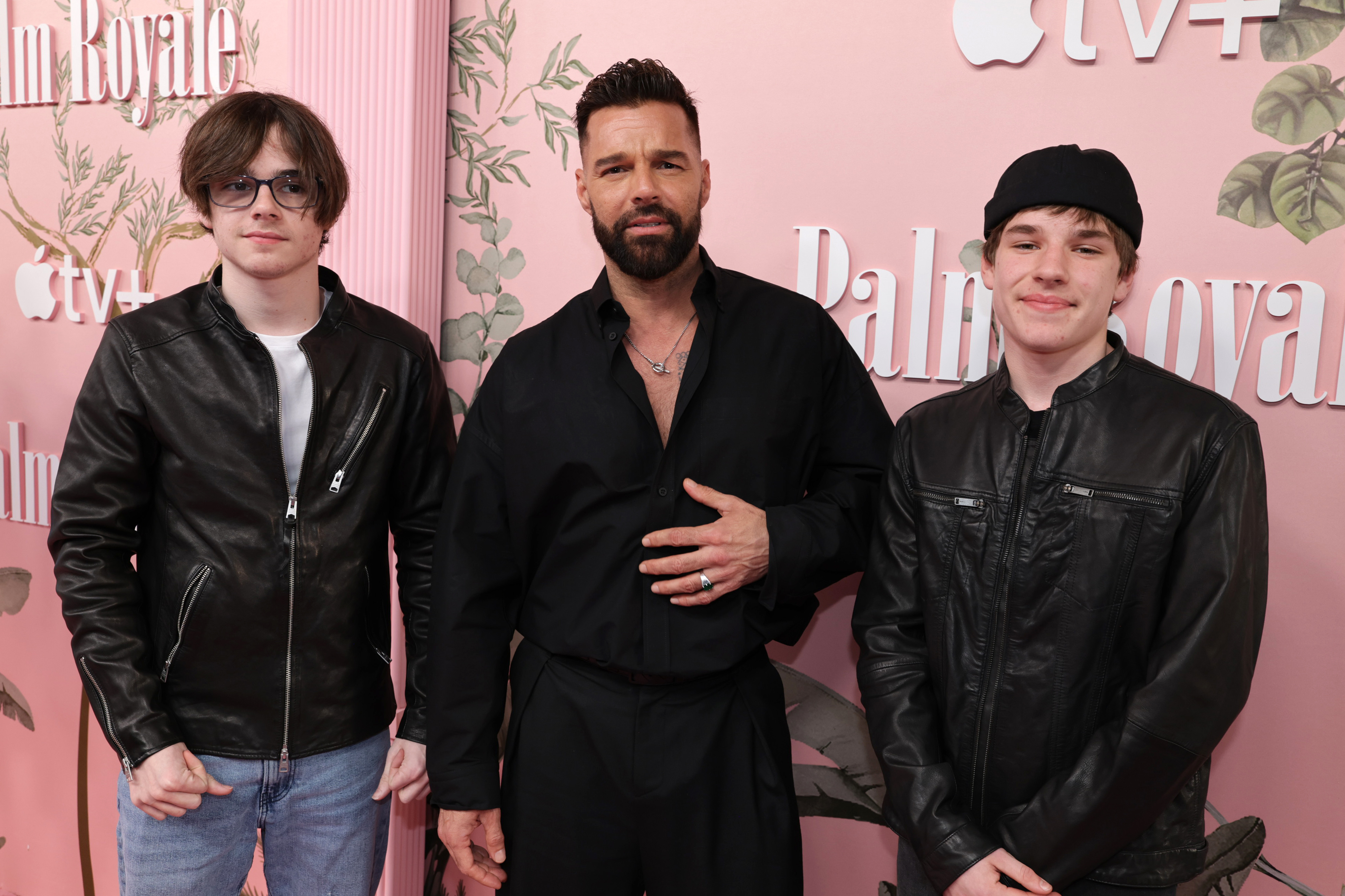 Valentino Martin, Ricky Martin, and Matteo Martin pose together at the world premiere of Apple TV+'s "Palm Royale" in Beverly Hills, with all three dressed in dark outfits.