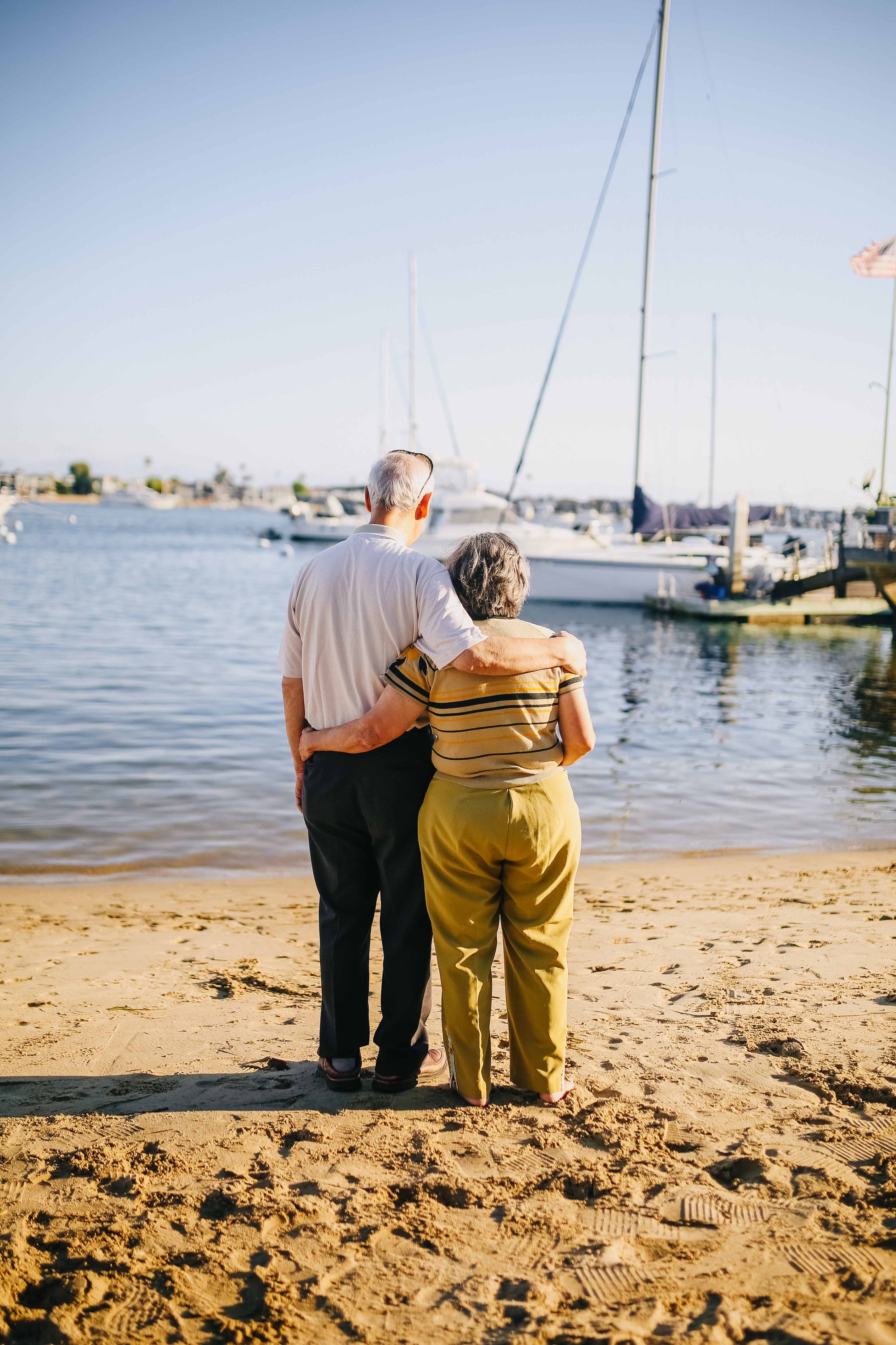 An elderly couple looking at the boats in the water. | Source: Pexels. 