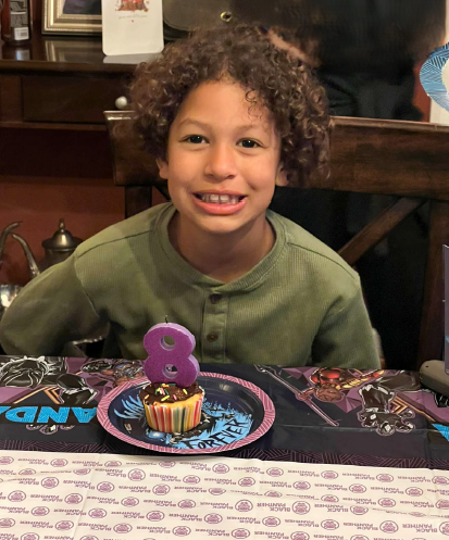 Lamar McGlothurn is shown celebrating his birthday with a cupcake and a bright smile | Source: State of California