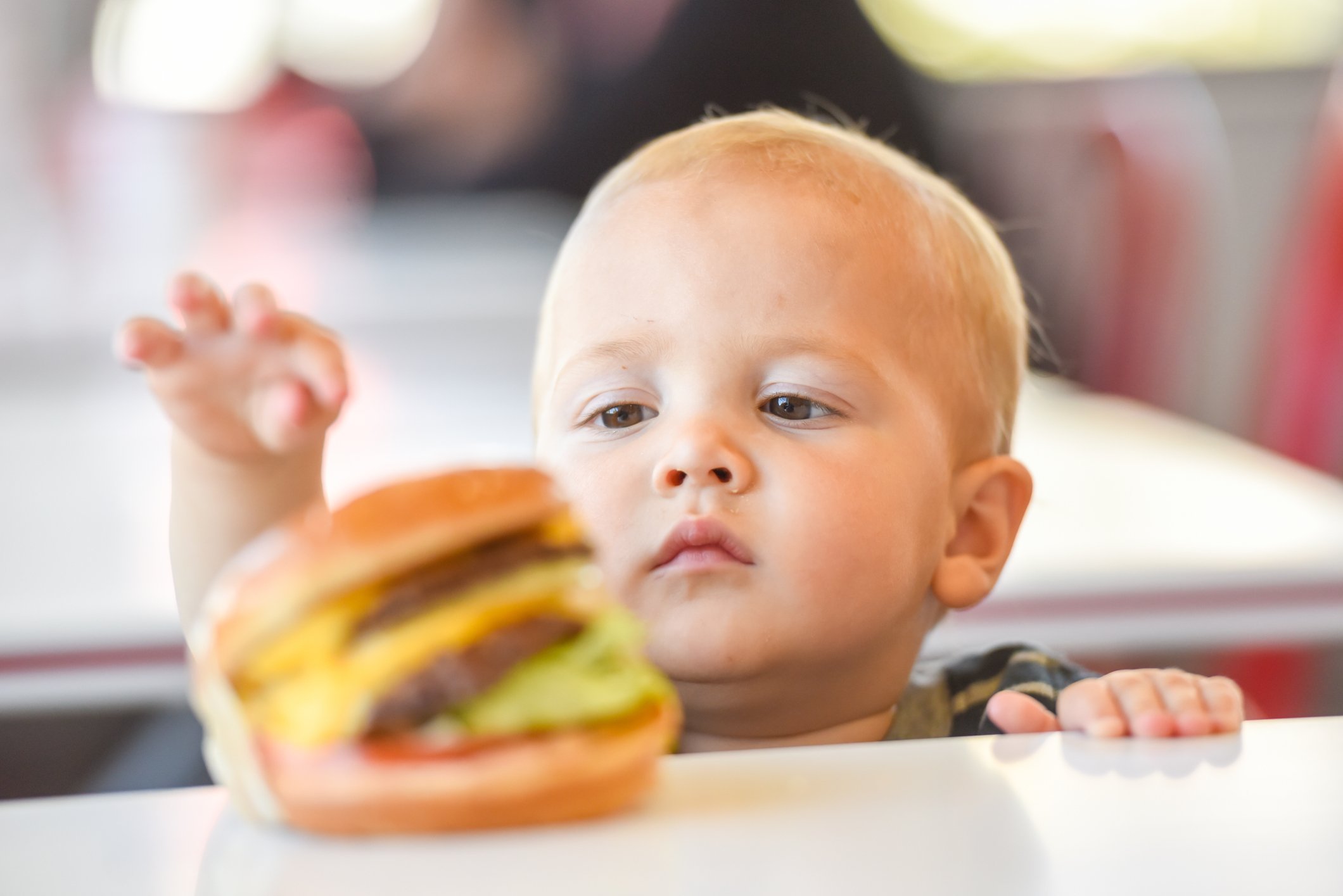 Baby versucht einen Hamburger zu schnappen  | Quelle: Getty Images