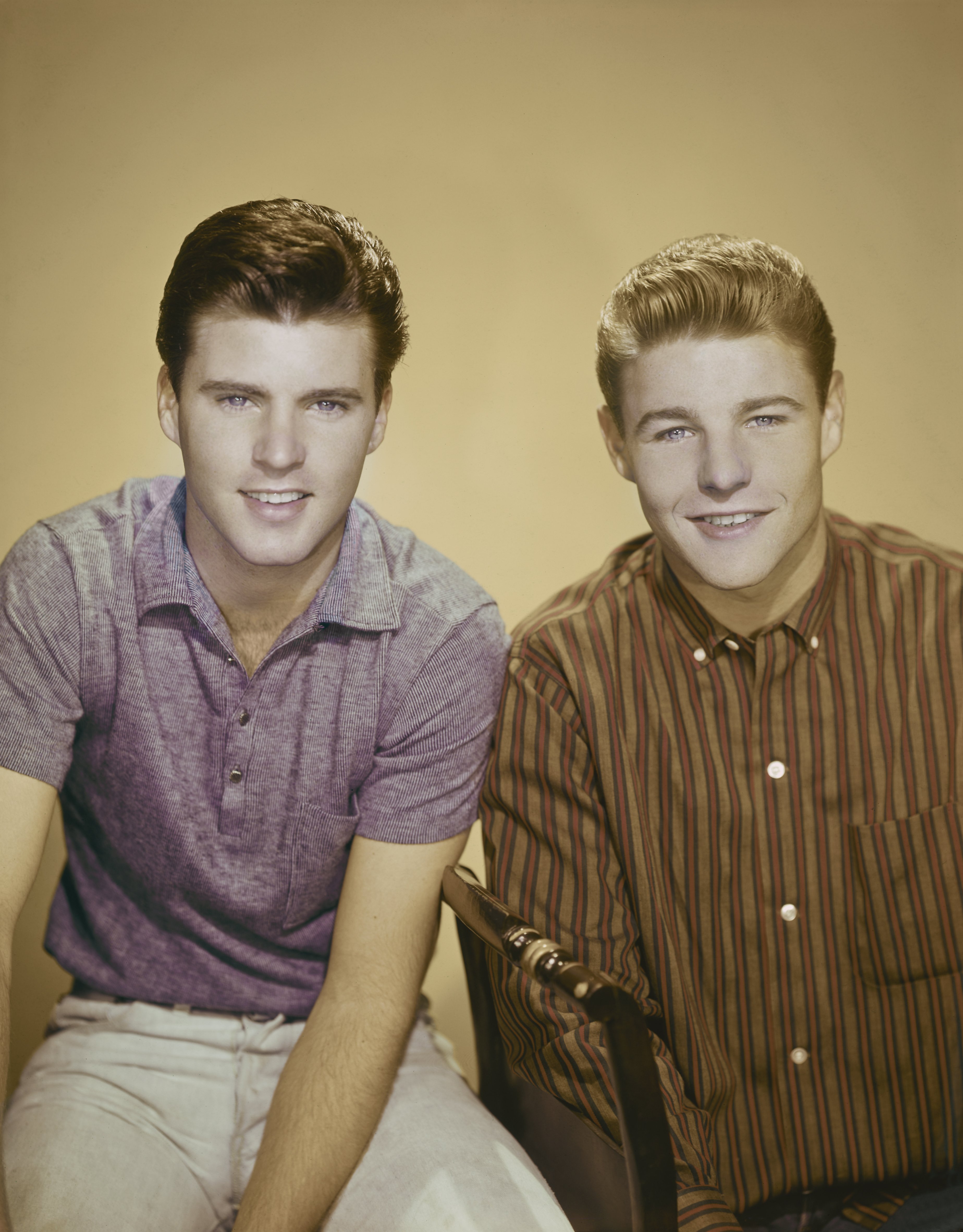Ricky Nelson and his brother David Nelson pose for a photo in 1957. | Source: Getty Images