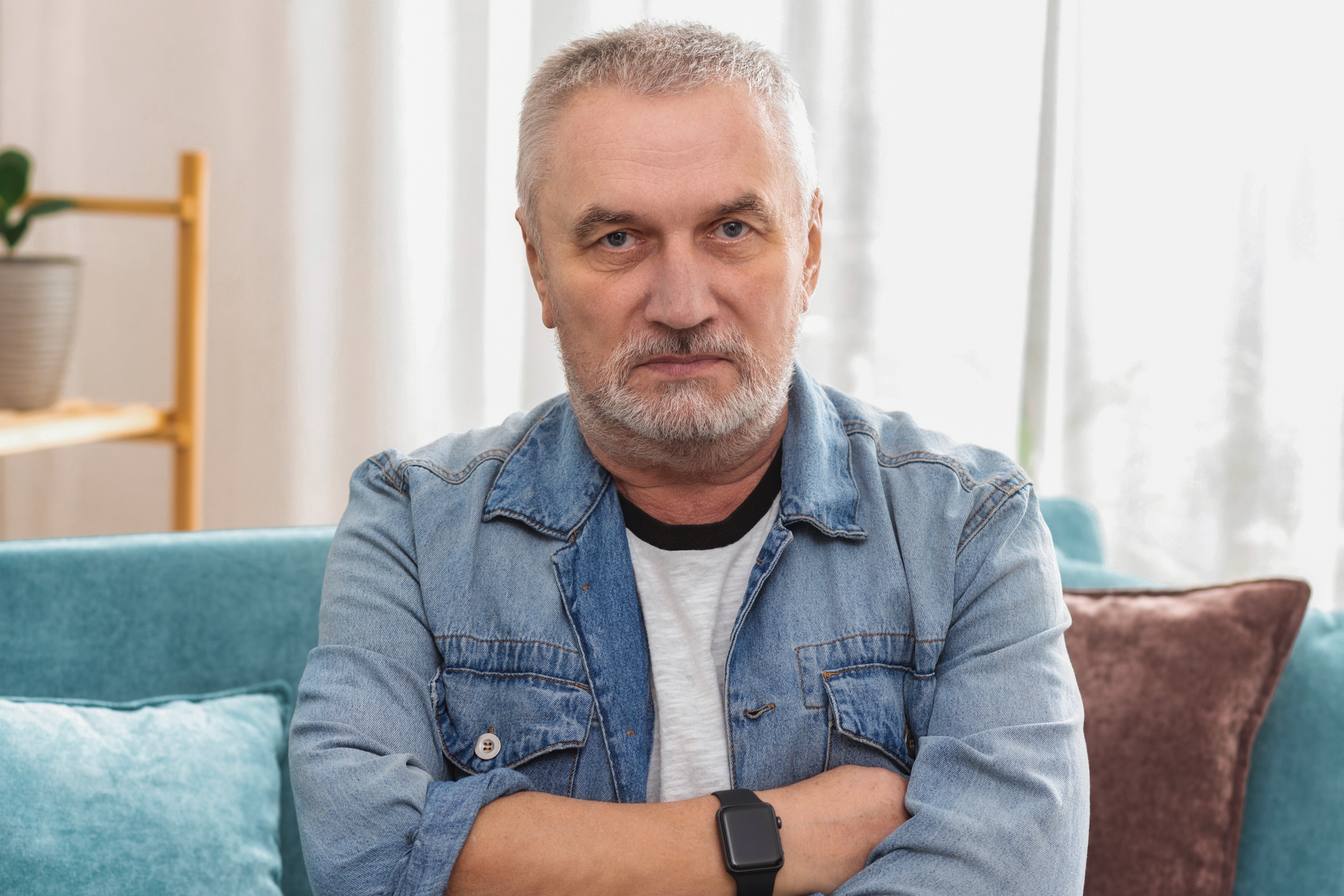 A senior man sitting on the sofa | Source: Shutterstock