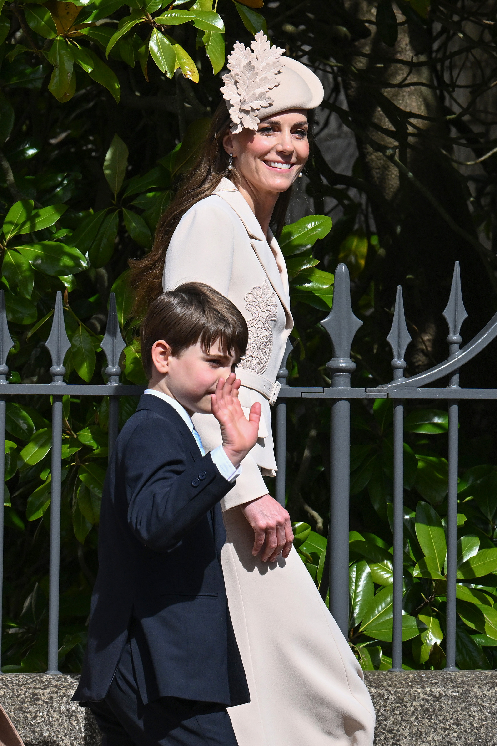 Prince Louis, 7, gives the crowds his own enthusiastic wave as he walks alongside the Princess of Wales towards St George's Chapel. Dressed in a smart navy suit with a pale blue shirt, he cuts a wonderfully earnest figure beside his mother, who smiles in profile. One fan had noted that Prince Louis was "shooting up" in height too, and this photo makes a rather convincing case.