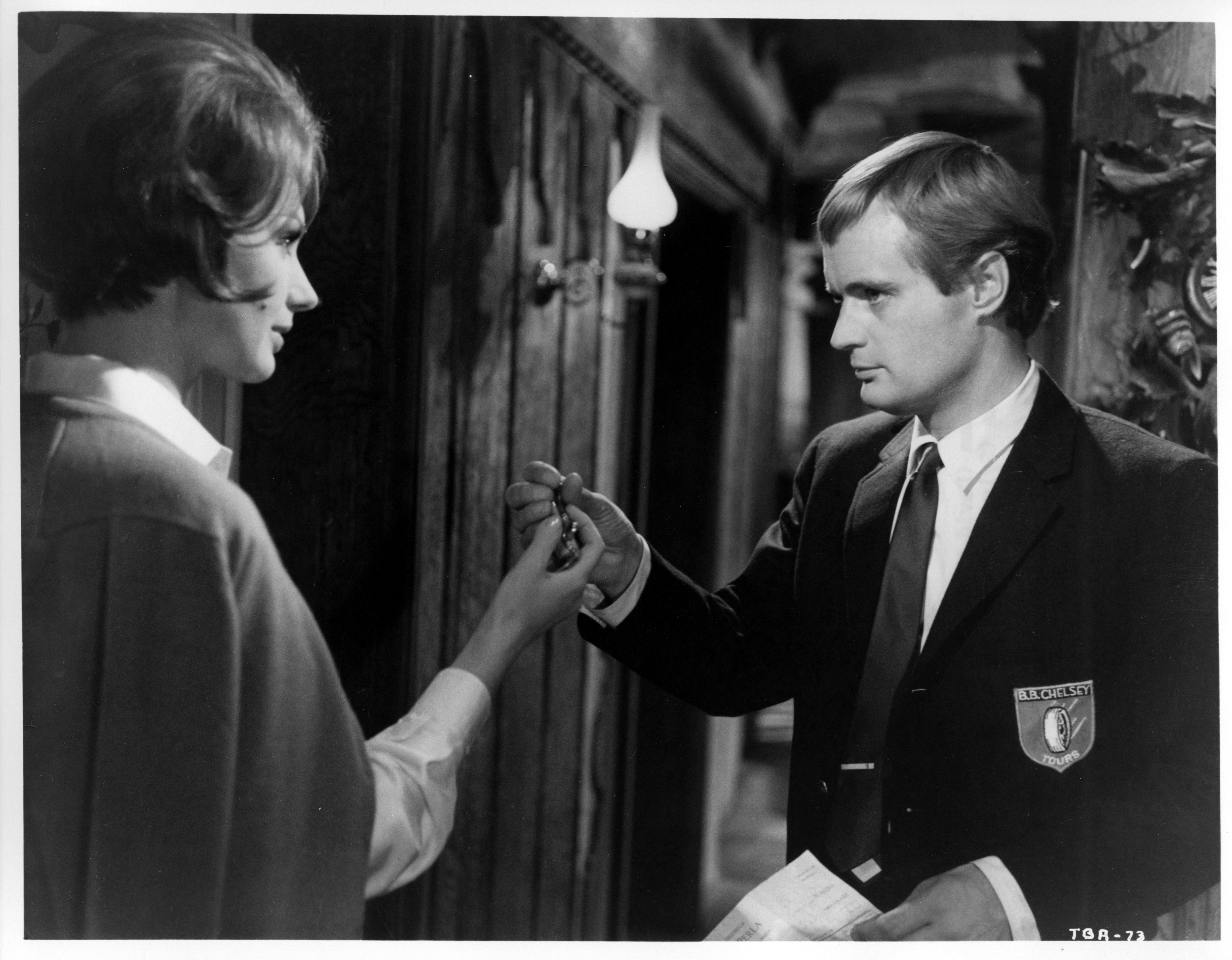 David McCallum shows Sylva Koscina her room in a scene from the MGM movie "Three Bites of the Apple", circa 1967. | Source: Getty Images