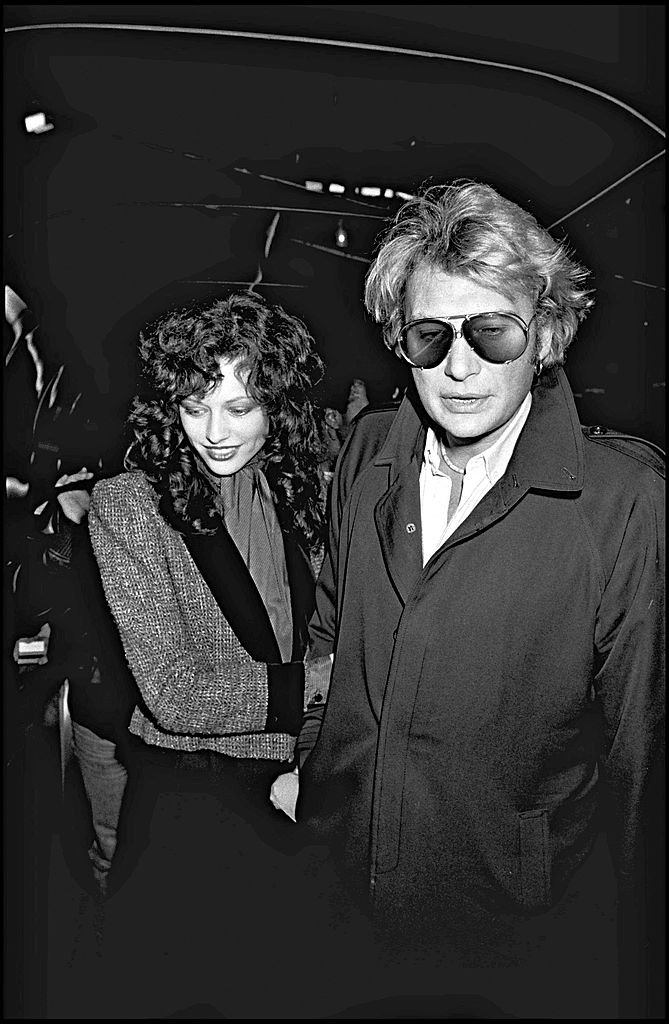 Johnny Hallyday et sa compagne Babeth Etienne à l'aéroport. | Photo : Getty Images