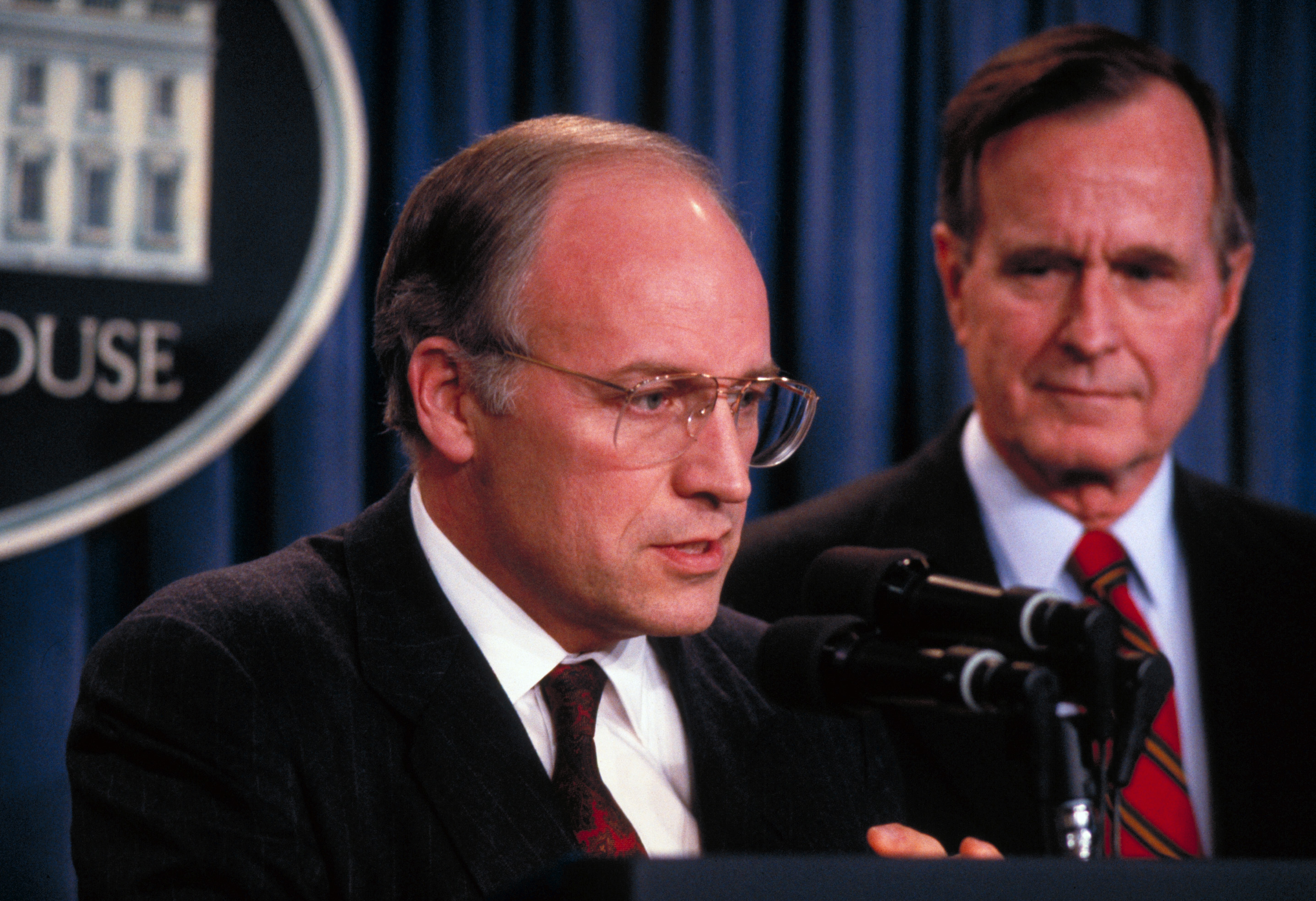 President George Bush looks on, as Defense Secretary-designate Dick Cheney speaks to the press on March 1, 1989 | Source: Getty Images