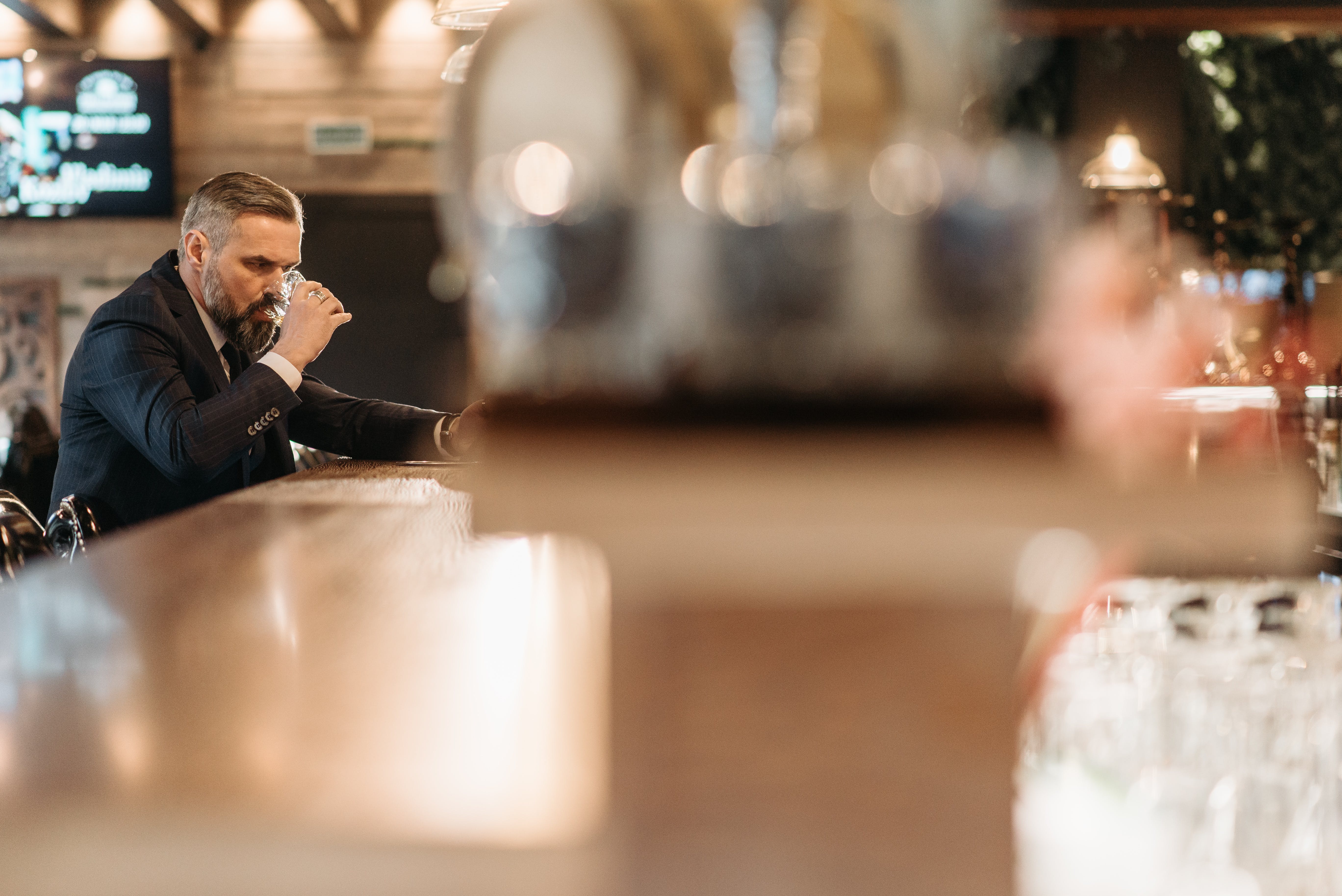 An older man having a drink at a bar | Source: Pexels