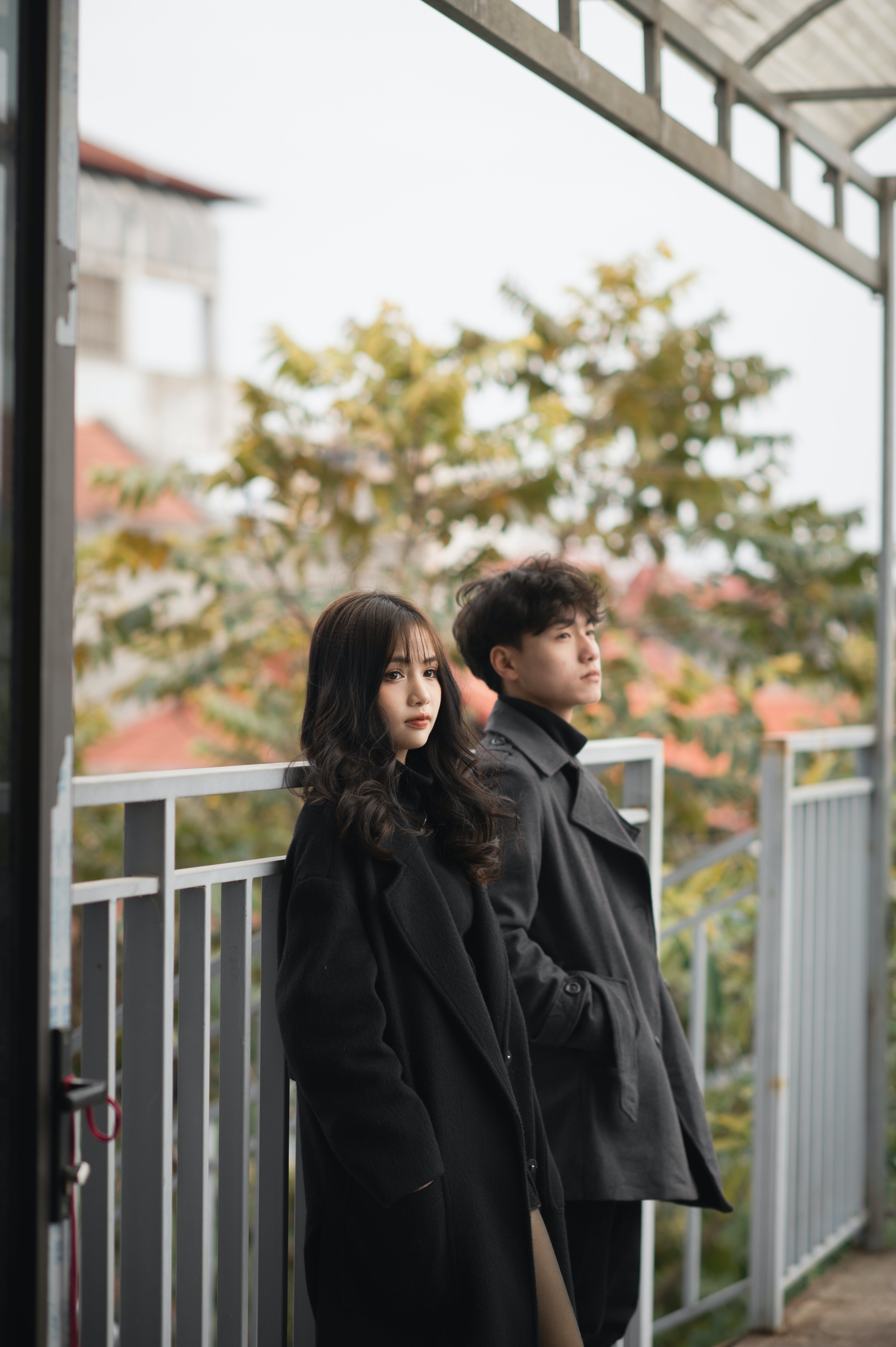 A young man and a woman standing on a Terrace. | Source: Pexels