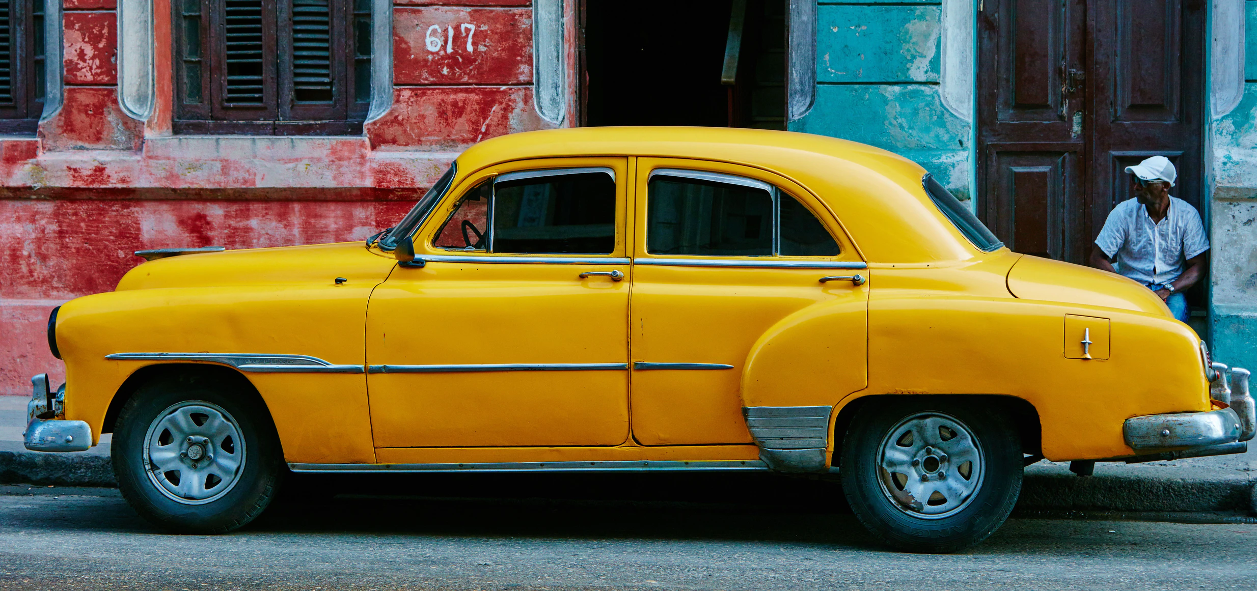 A yellow Sedan parked near the road. | Source: Unsplash