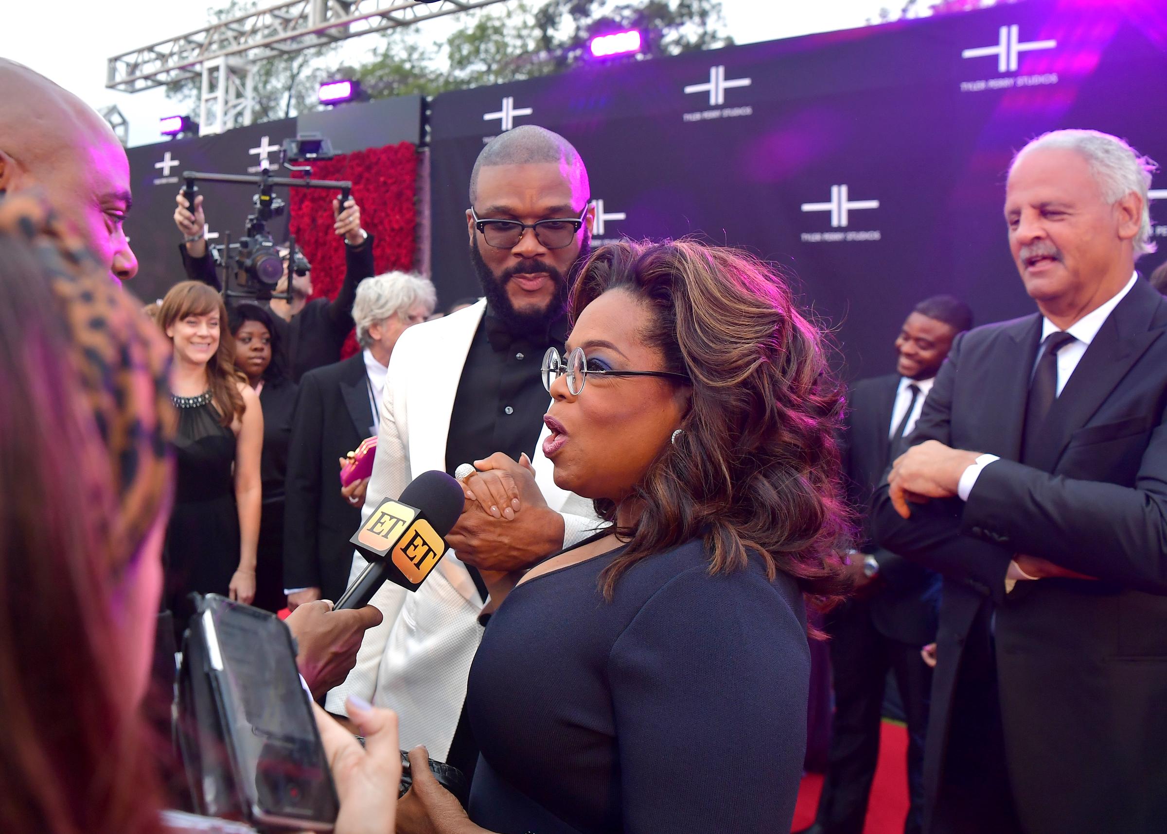 In another image from the same gala, Winfrey spoke with reporters as Graham stood nearby. Tyler Perry was also pictured beside her during the red carpet appearance. | Source: Getty Images